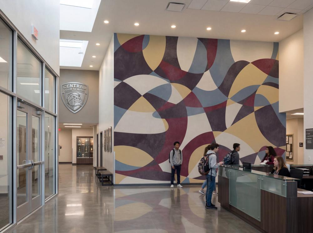 the entrance hall at a high school with an abstract wall mural on the wall