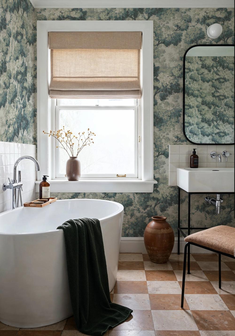 a photo of a bathroom with a lush leaves themed wallpaper on the walls
