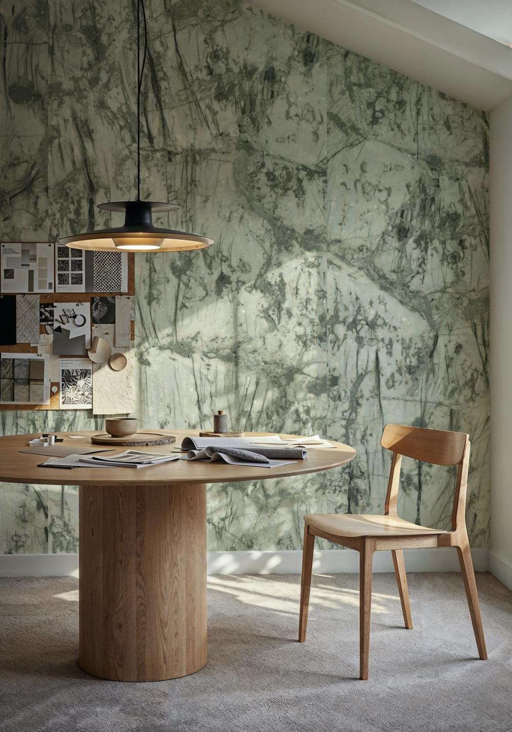 a photo of a home art studio with green marbled themed wallpaper on the walls