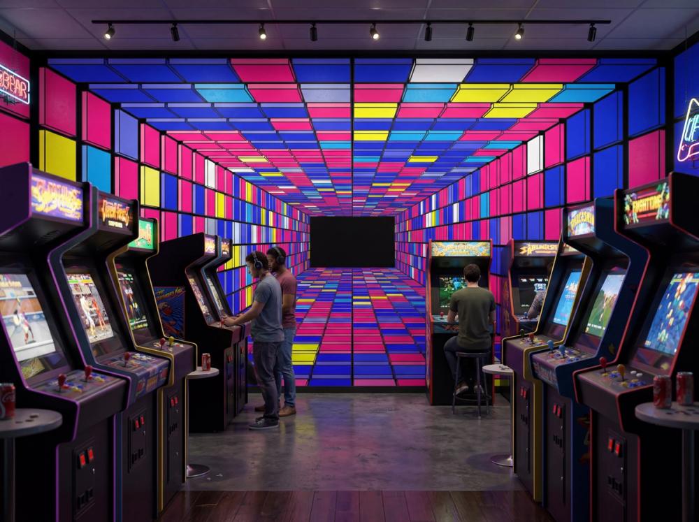 an interior image of a retro gaming arcade with a tunnel themed wallpaper mural on the prominent wall