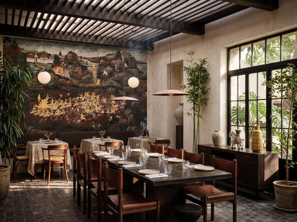an interior photo of a thai restaurant with a large large traditional thai painting on the wall