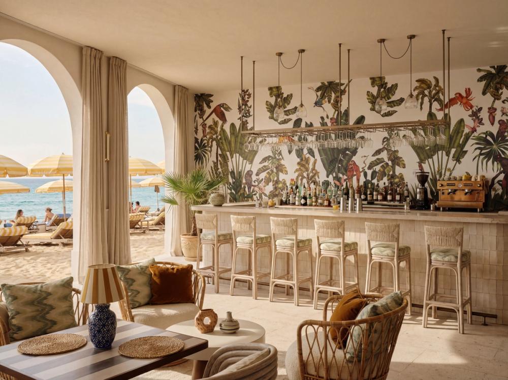 an interior photo of a beach bar with a tropical themed wall mural behind the bar