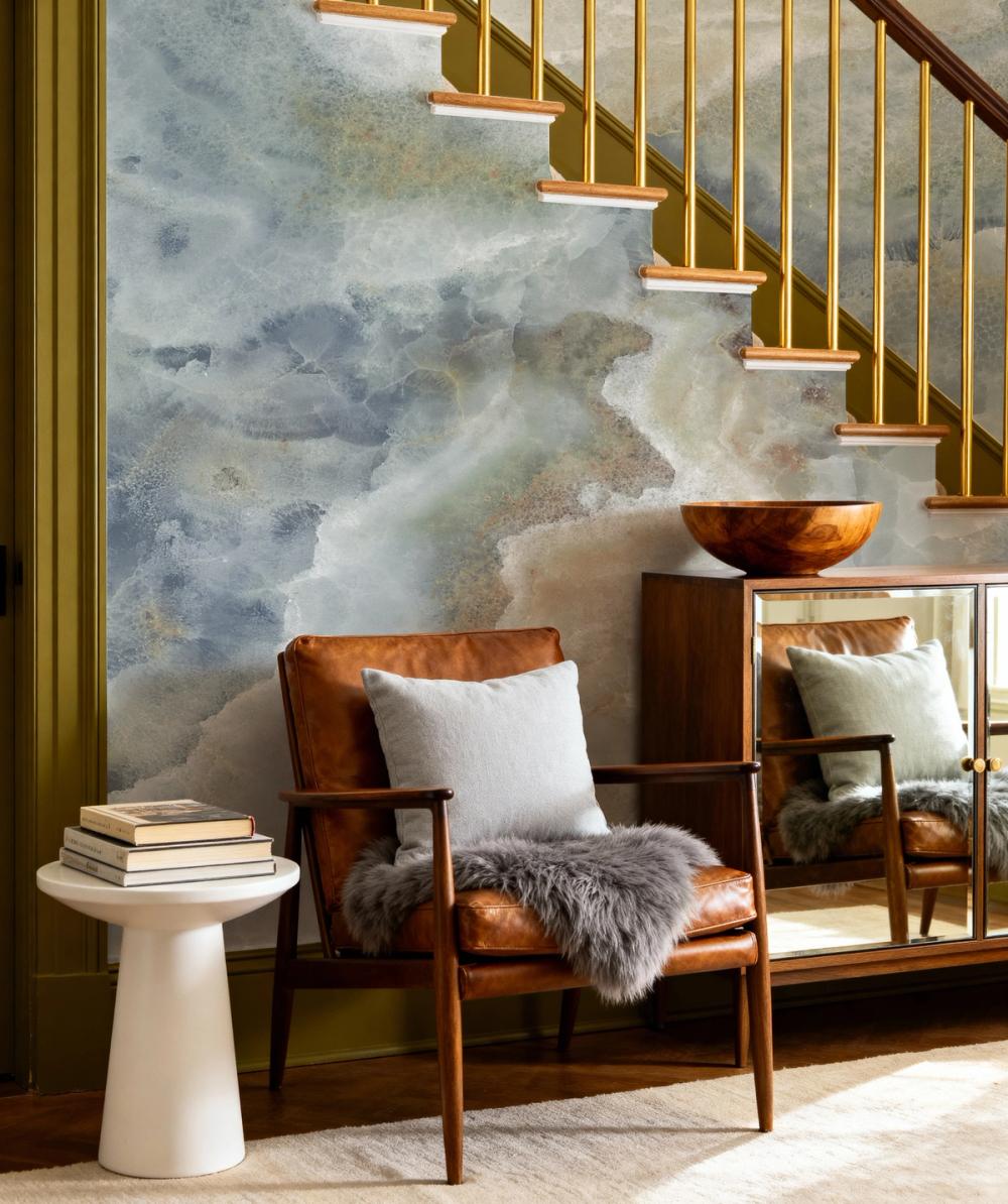 A photo of an entrance hallway with a marble themed wallpaper om the walls in soft blue hues