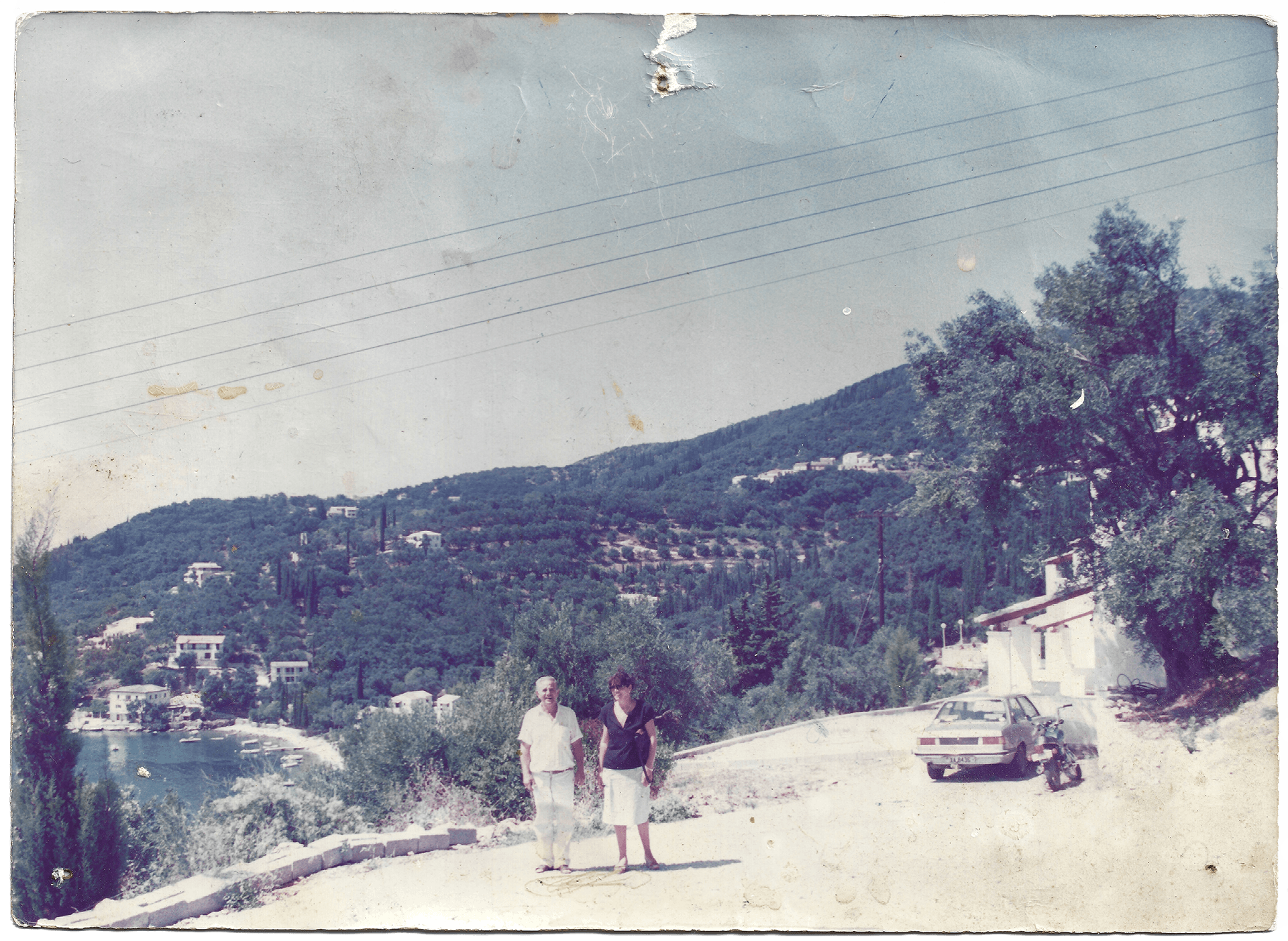 Vintage photograph of a couple standing on what today is Villa Natalia overlooking the bay of Kalami in Corfu, showcasing the early history of Villa Natalia.