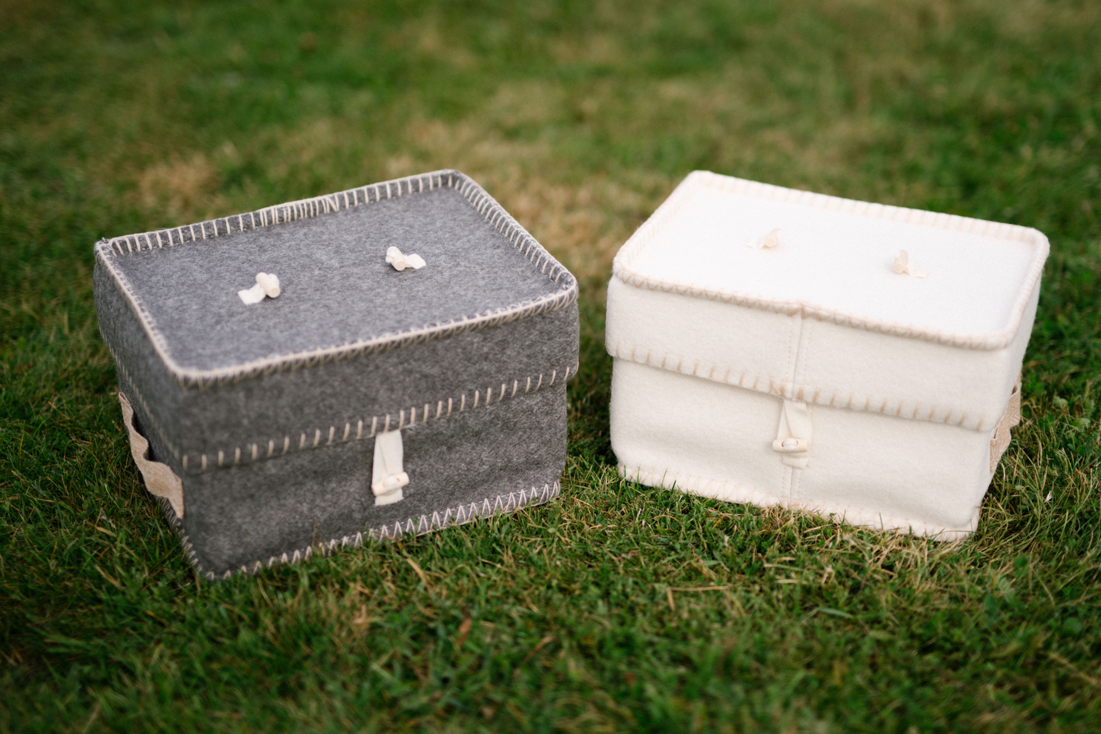 grey and white box shaped wool urn for ashes.