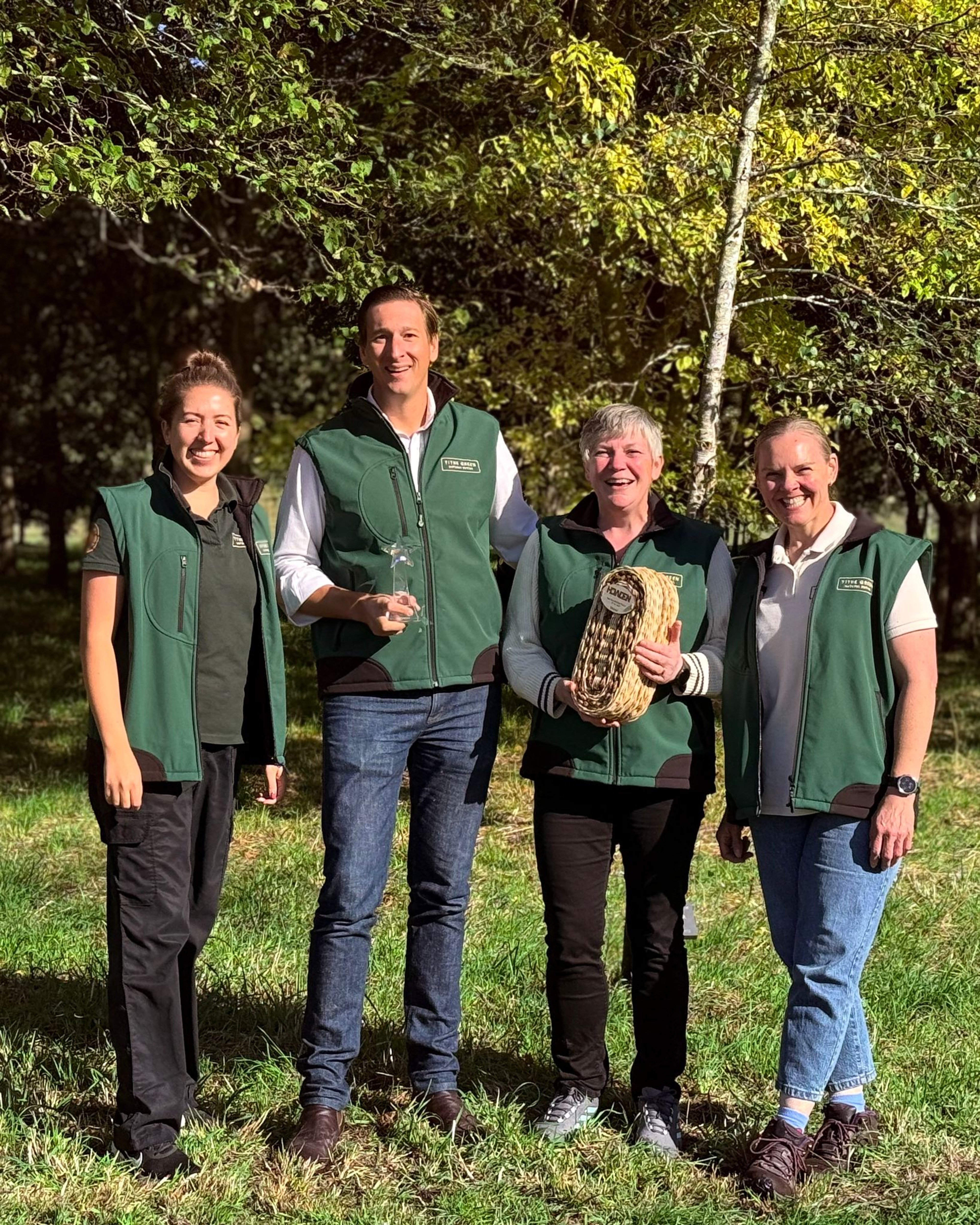 the Tithe Green team holding their Best Natural Burial Ground award