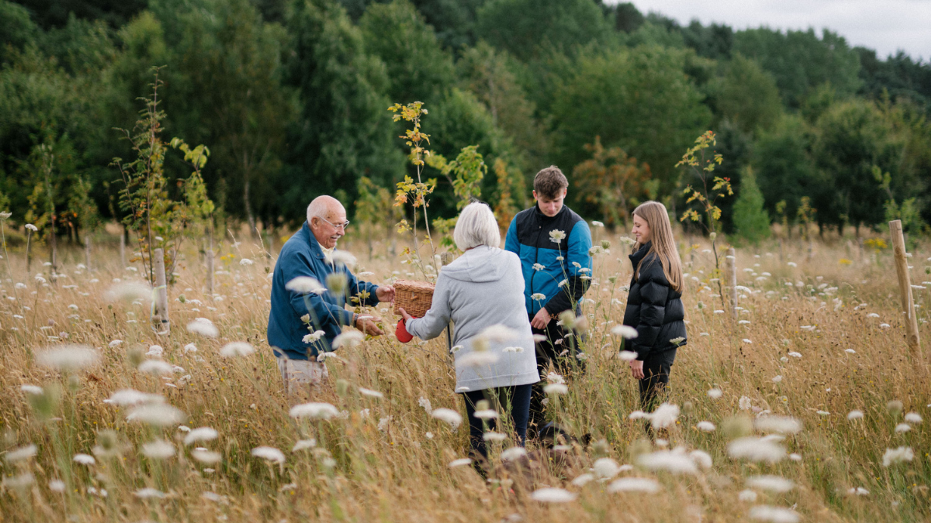 Family Interring Ashes in Wildflower Meadow