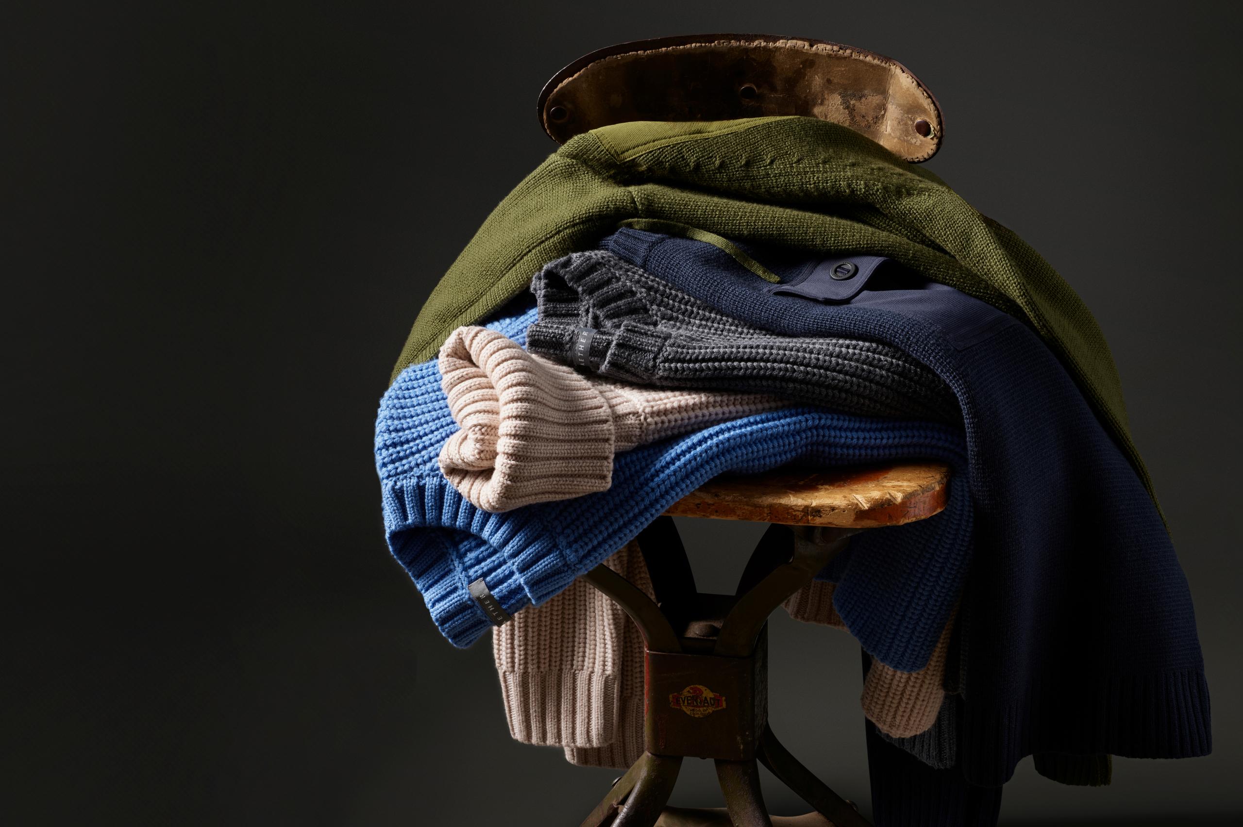 Stack of sweaters sitting on vintage stool