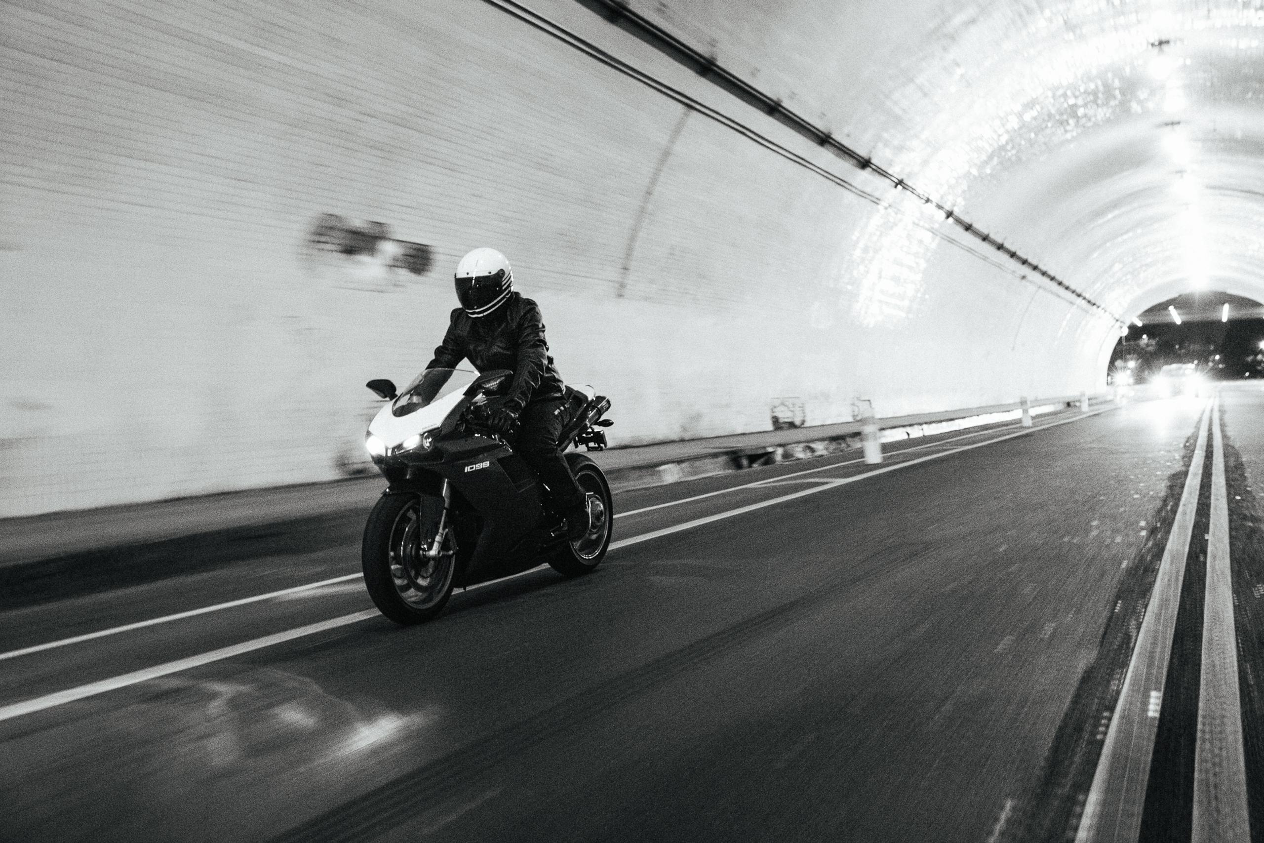 man riding motorcycle through tunnel