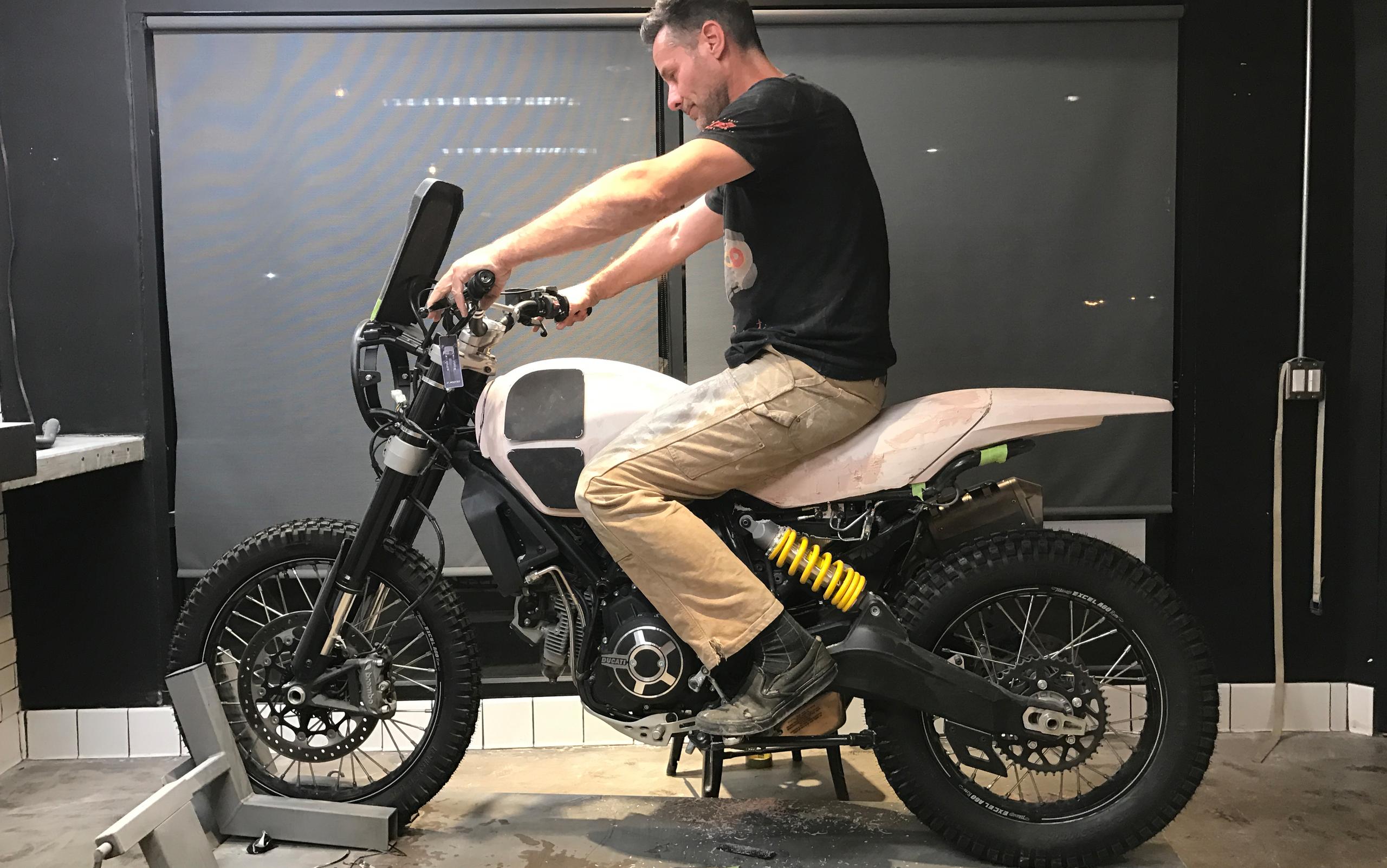 Alex Earle sitting on motorcycle prototype