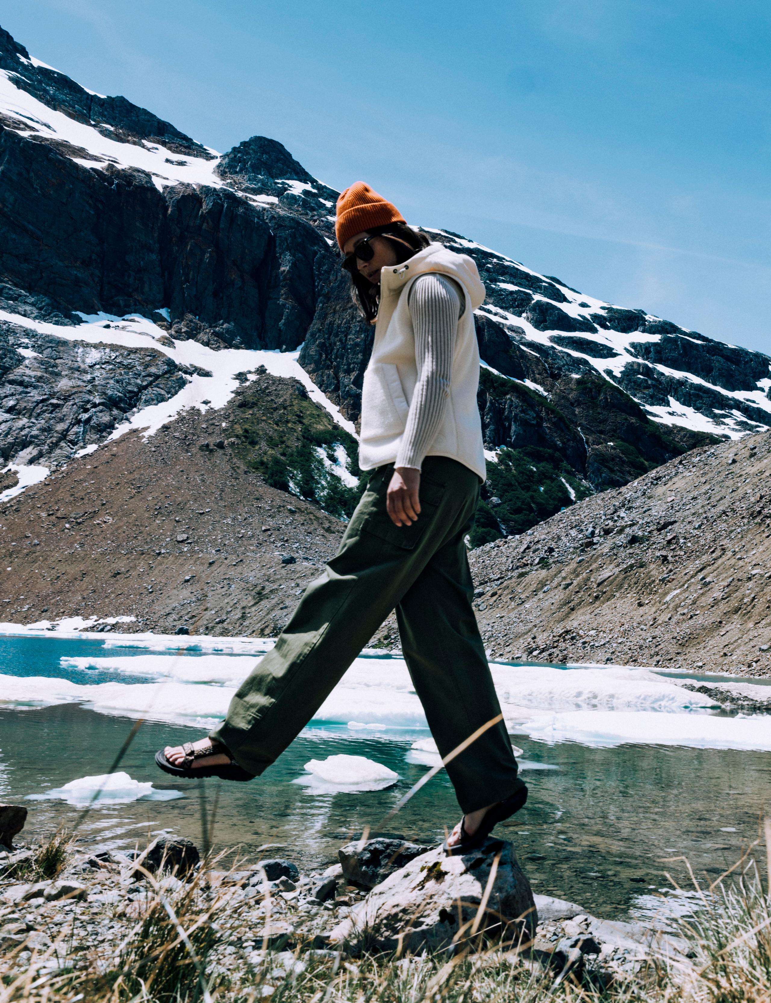 Woman walking along lake's edge in Patagonia