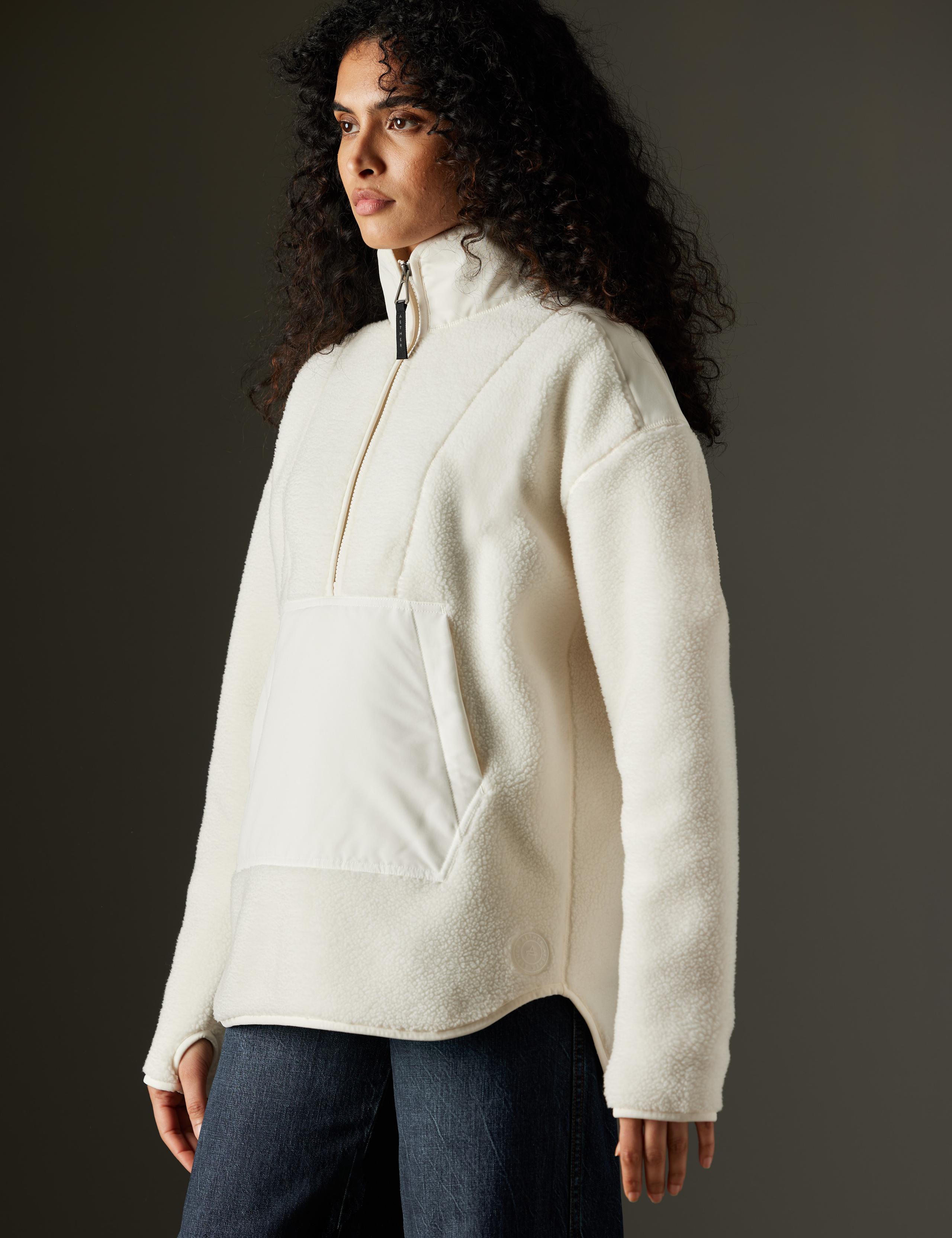 Woman in studio wearing the Terrain Fleece Anorak in Winter White
