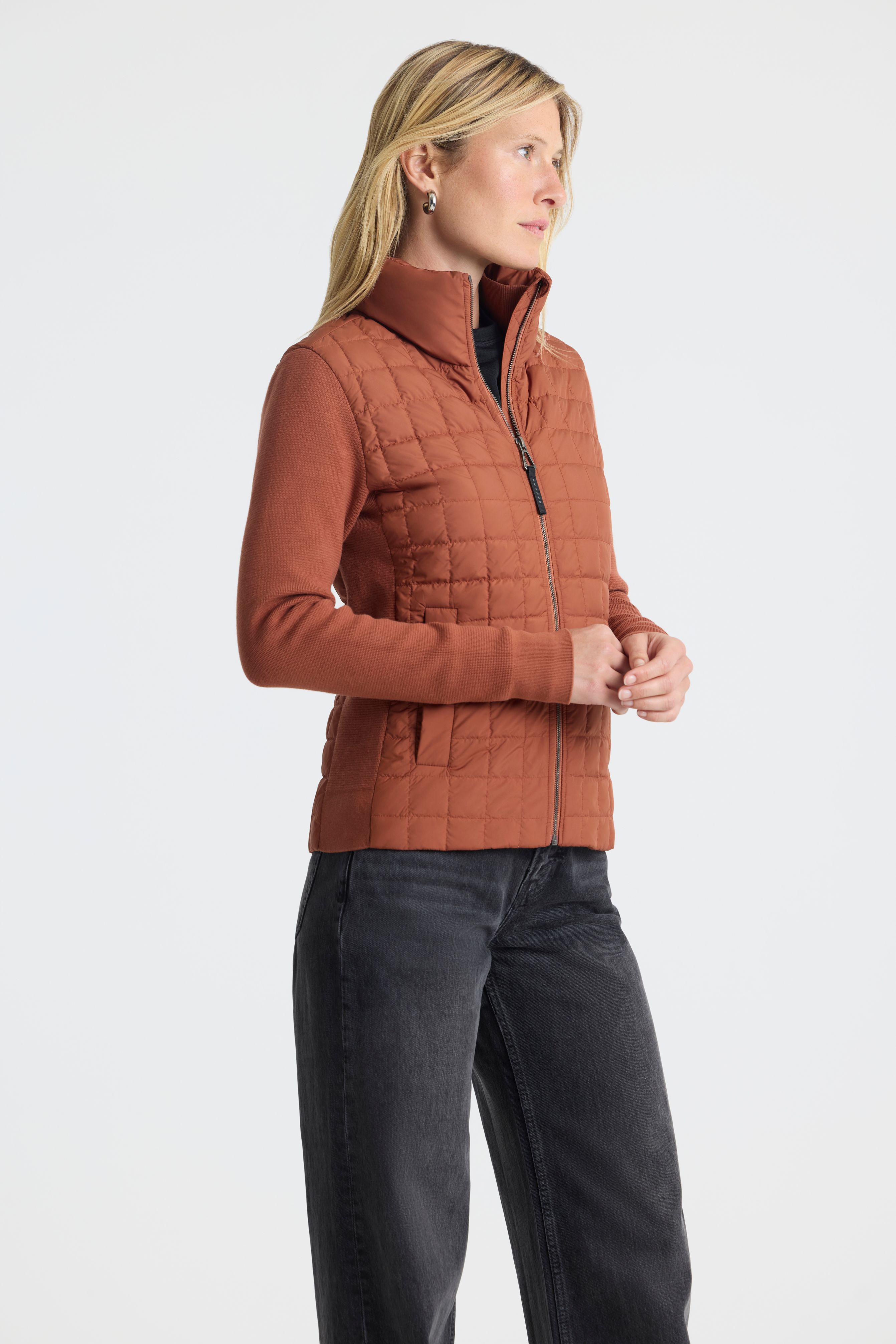 Woman in studio wearing Phase Full-Zip in Redwood Rust