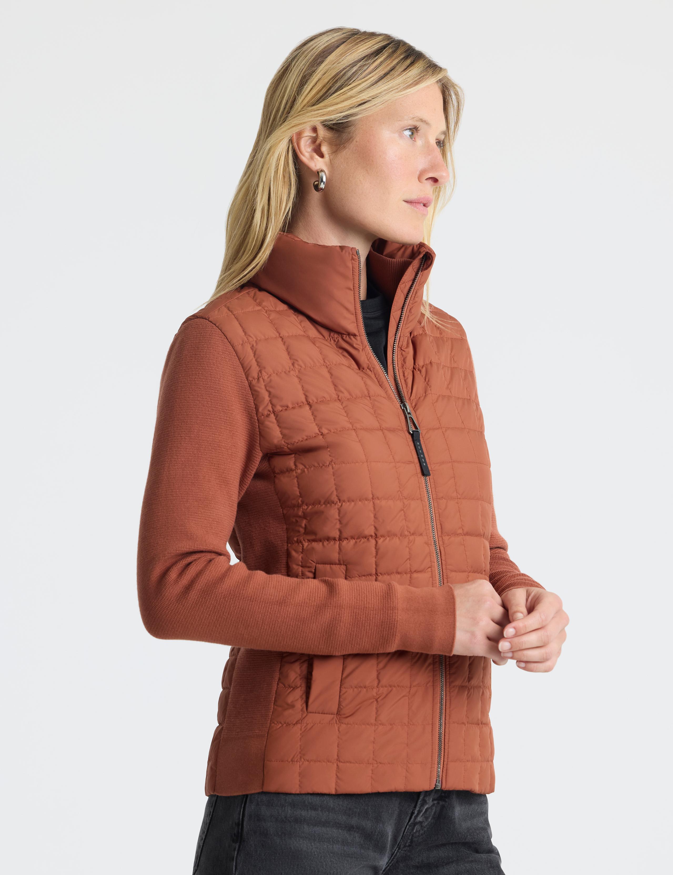 Woman in studio wearing Phase Full-Zip in Redwood Rust
