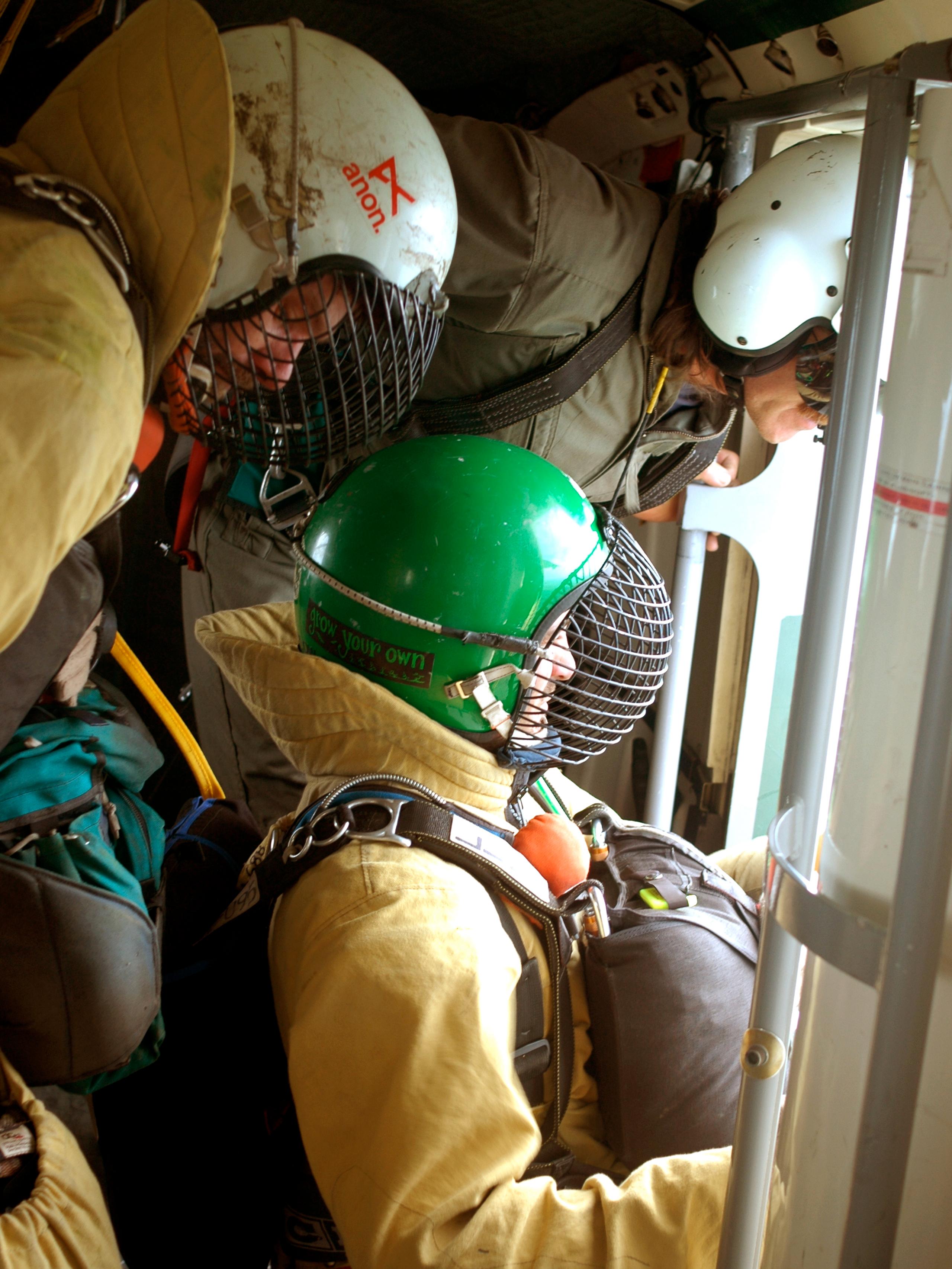 View from inside airplane of smokejumpers ready to jump