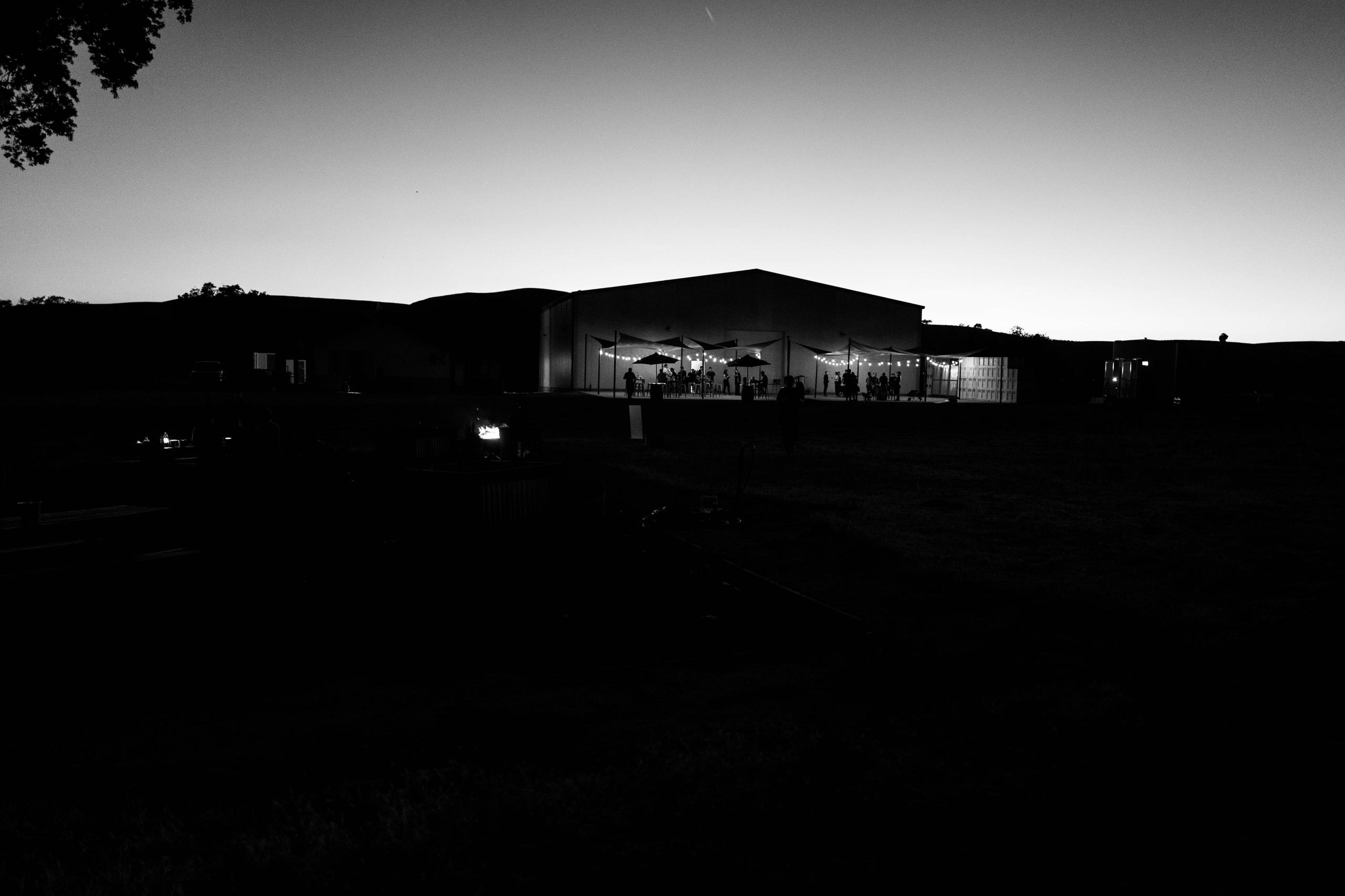 Black and white photo of campsite and winery at night