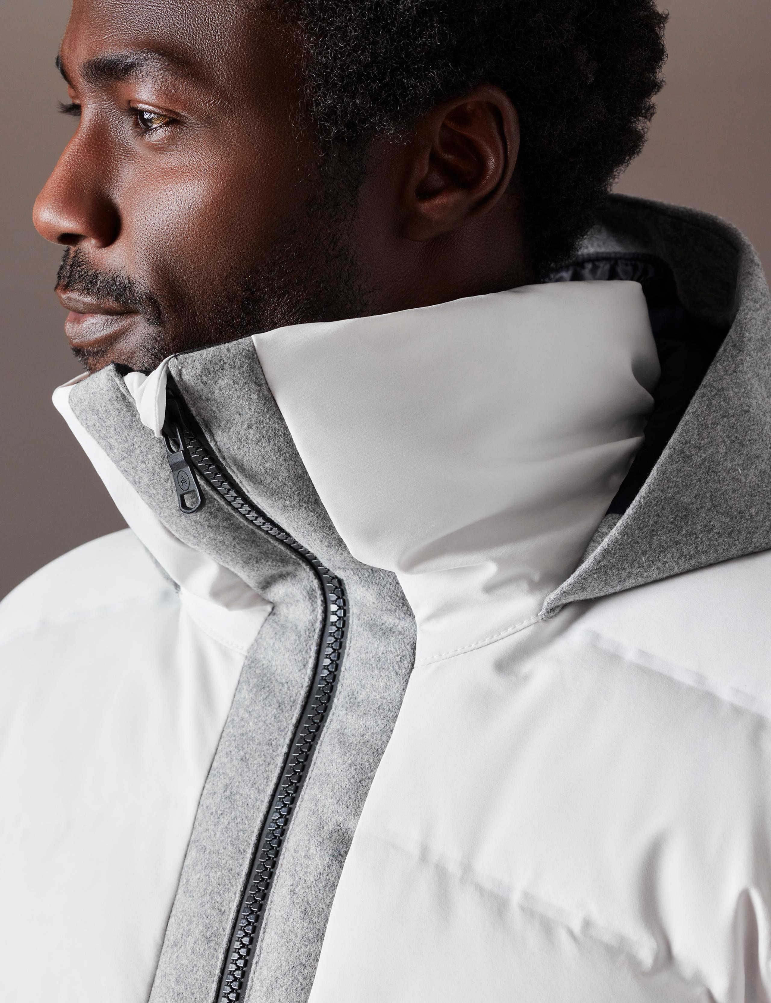 Profile view of man wearing the Nordic Jacket with the hood up