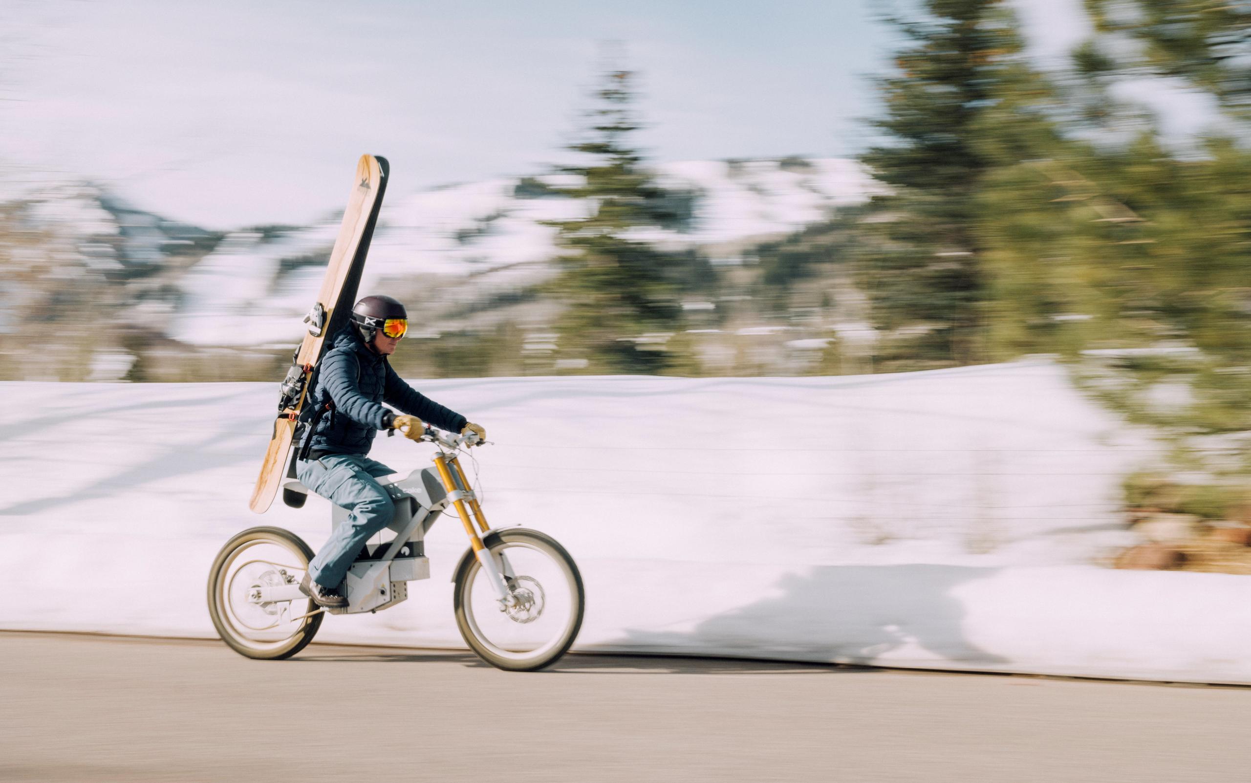 Men wearing Explore Snow Pant on cake bike heading to ski