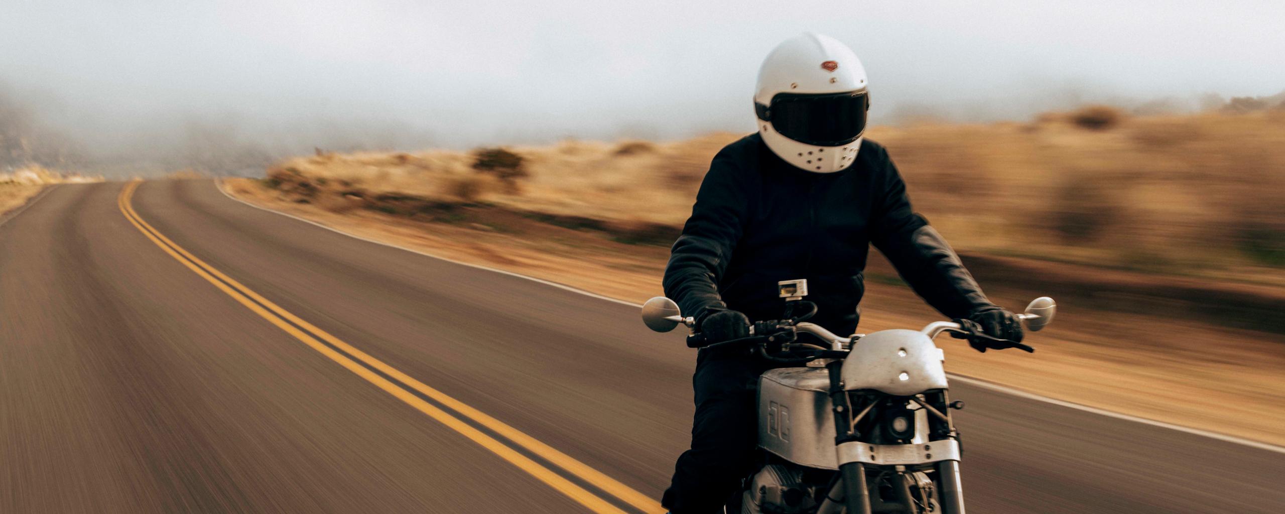 Man riding motorcycle down California road