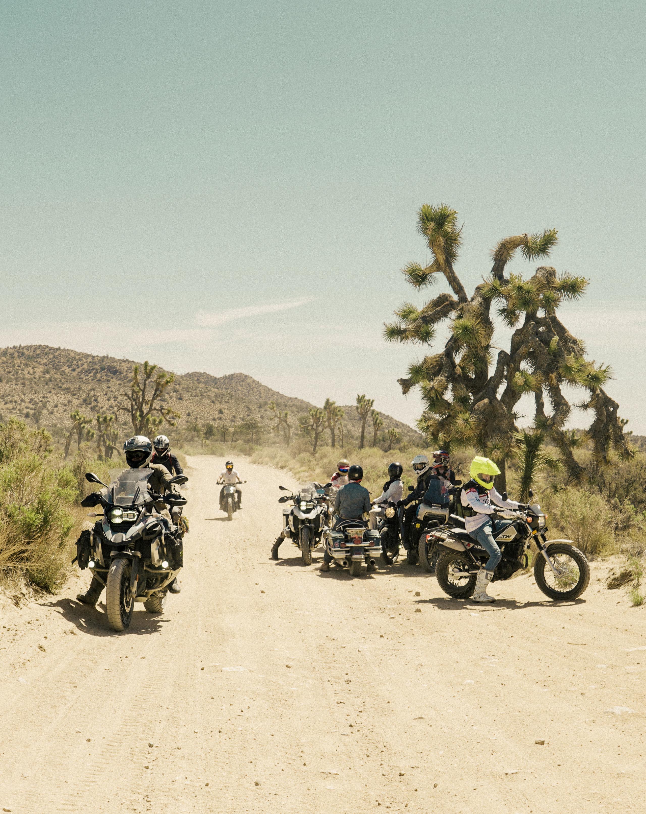 Group of motorcyclists on dirt road in Joshua Tree