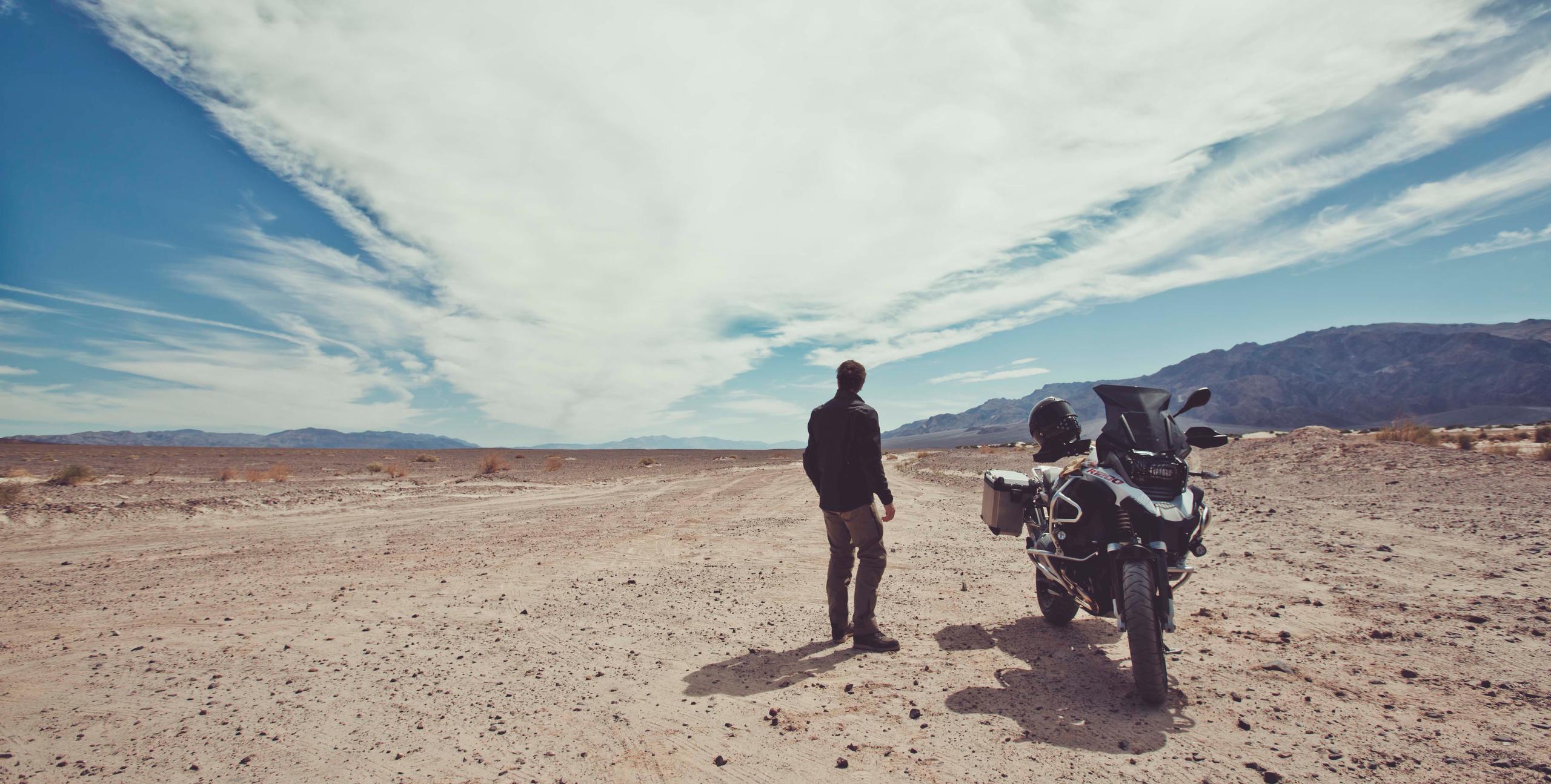 Man wearing Navigator Motorcycle Jacket standing next to a motorcycle in Northern California