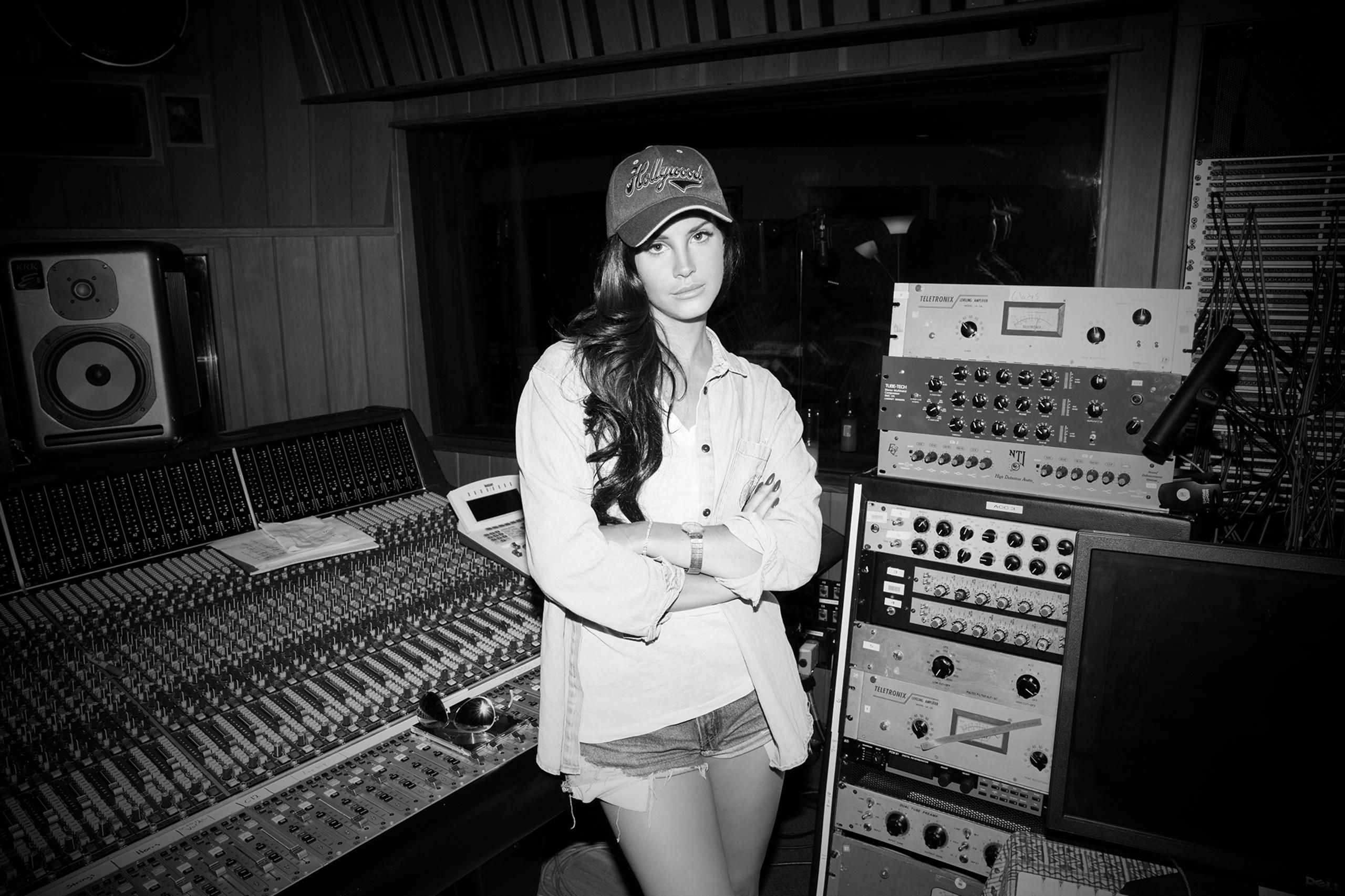 Lana Del Rey standing in recording studio with arms crossed