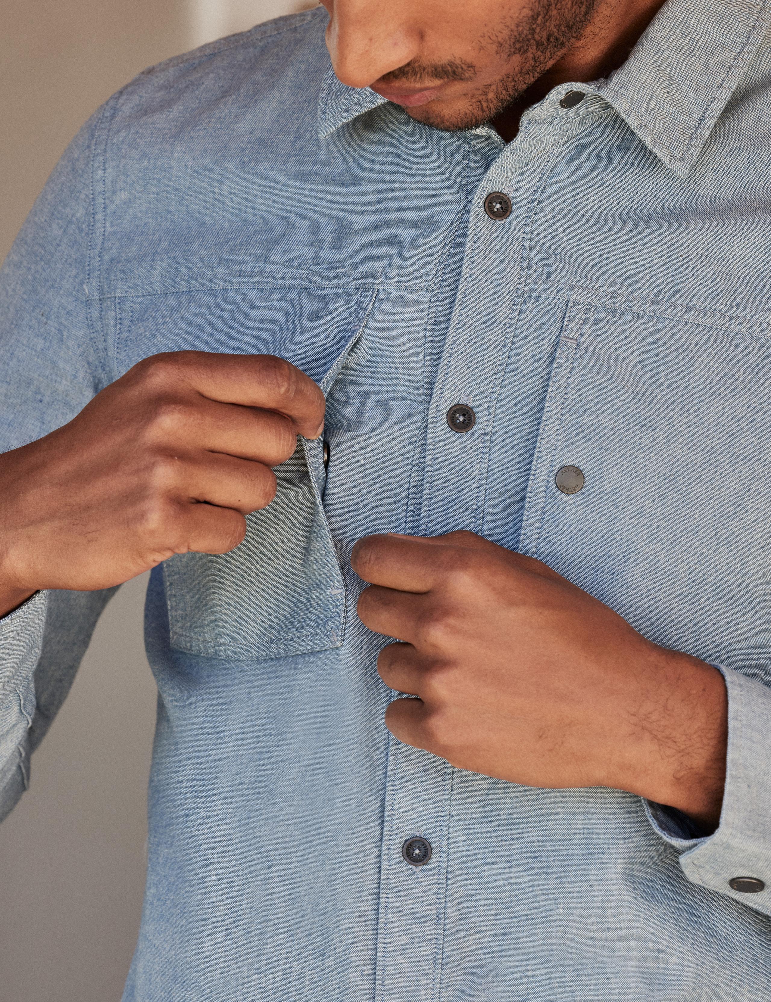 Detail of chest pocket of man wearing Chambray Button-Down