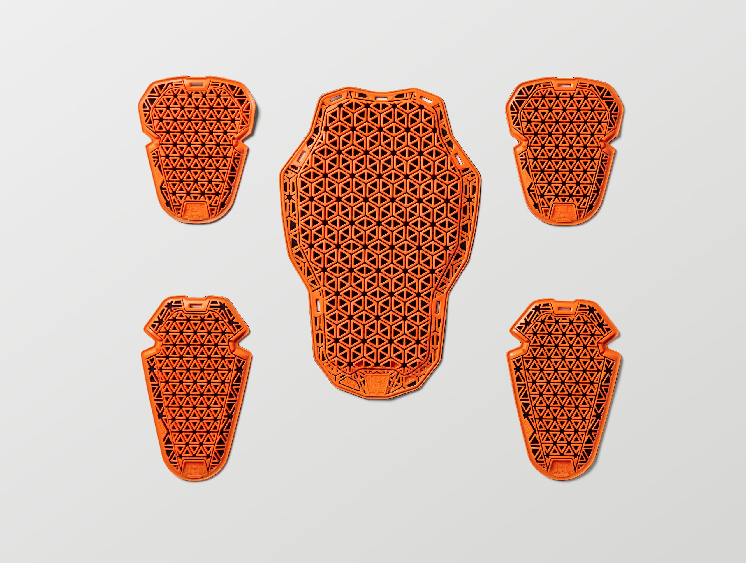 Studio laydown of D3O® orange Ghost™ pads