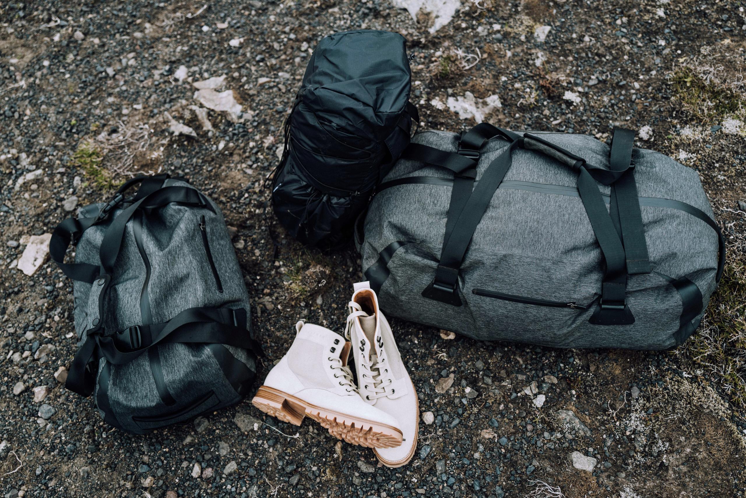 Luggage bags and shoes on ground in Iceland