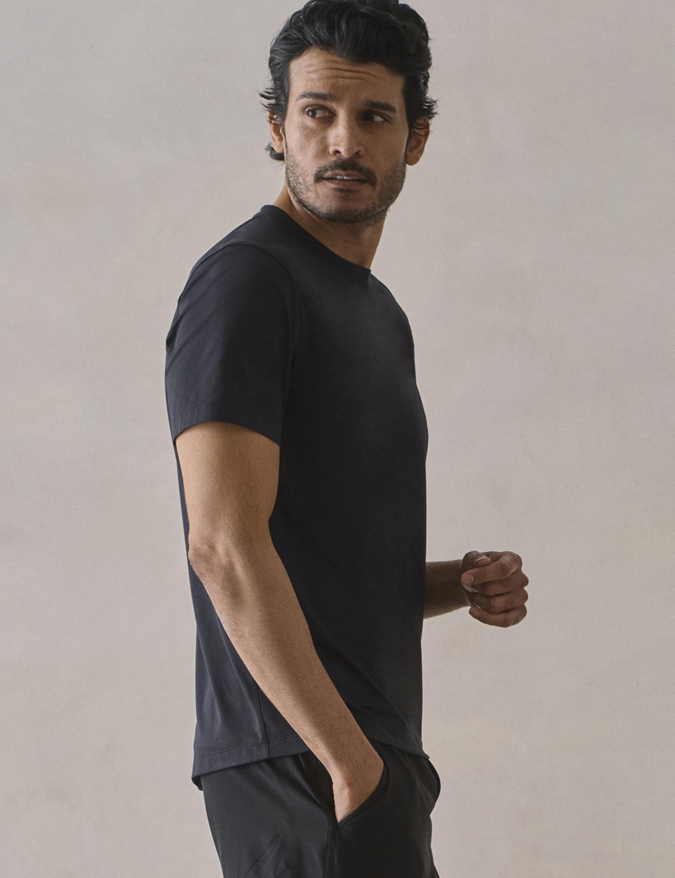 Man wearing black Performance Short Sleeve Tee