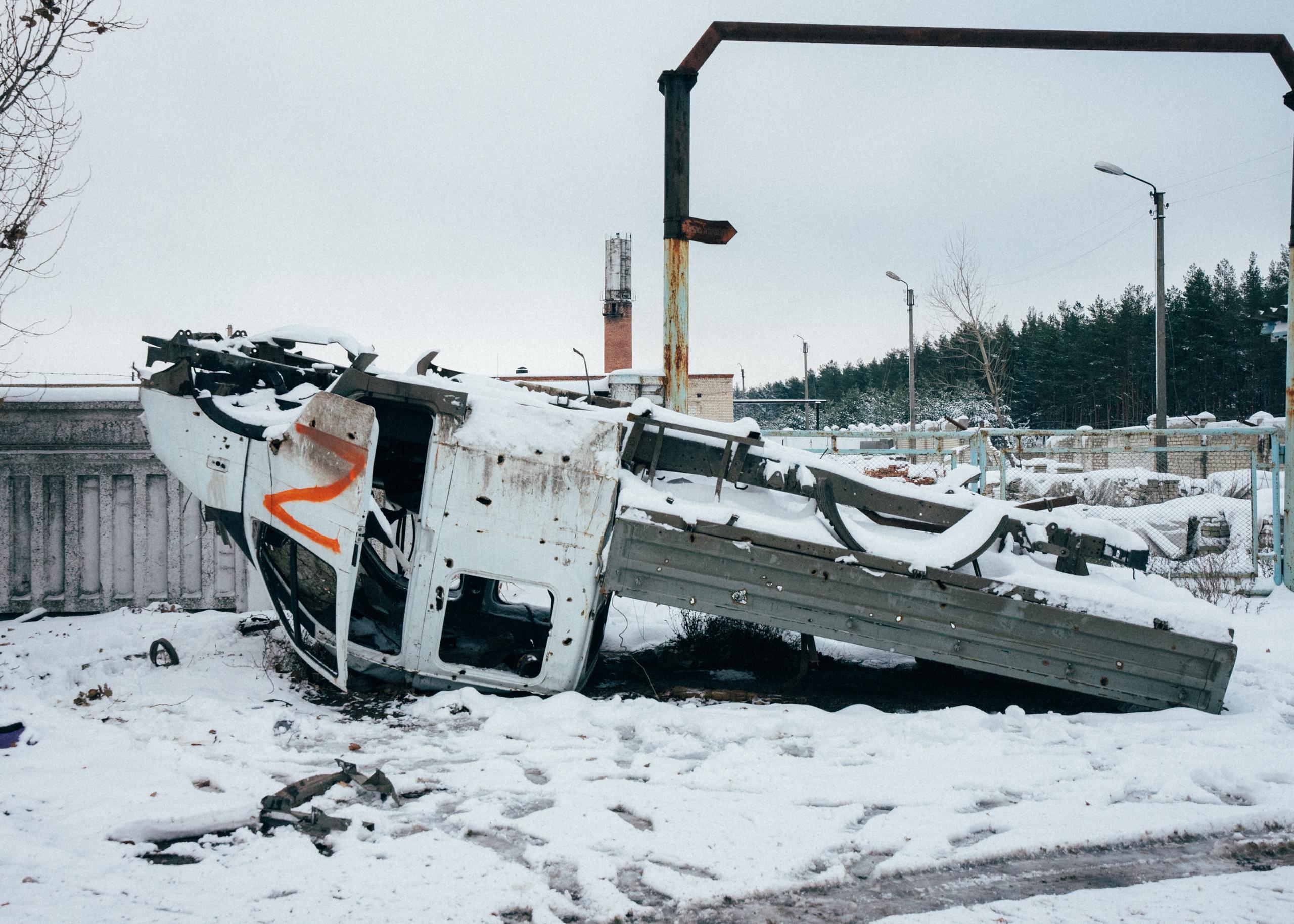 Flipped over Russian truck with orange marked Z on the side