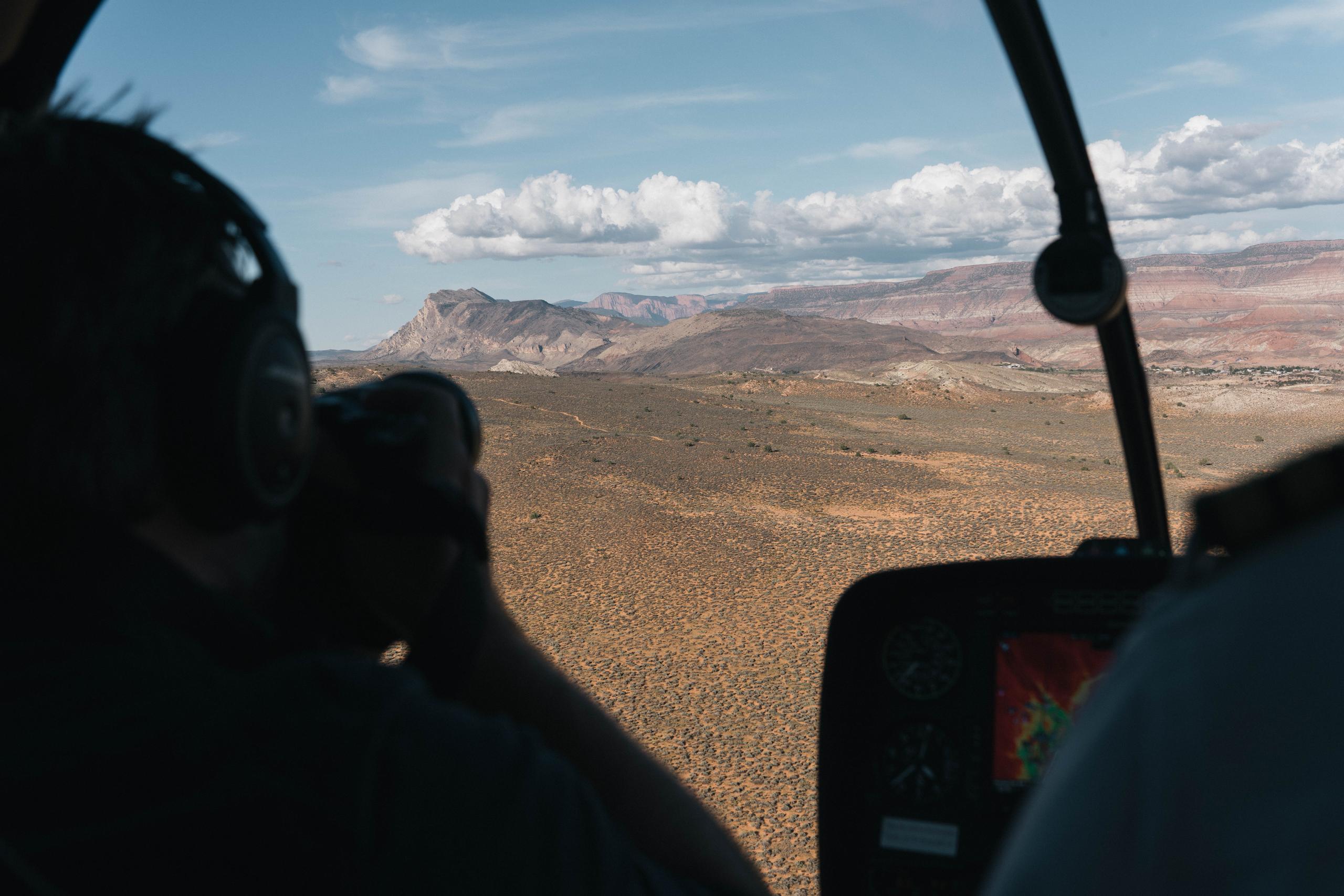 Photographer in helicopter overlooking Zion National Park