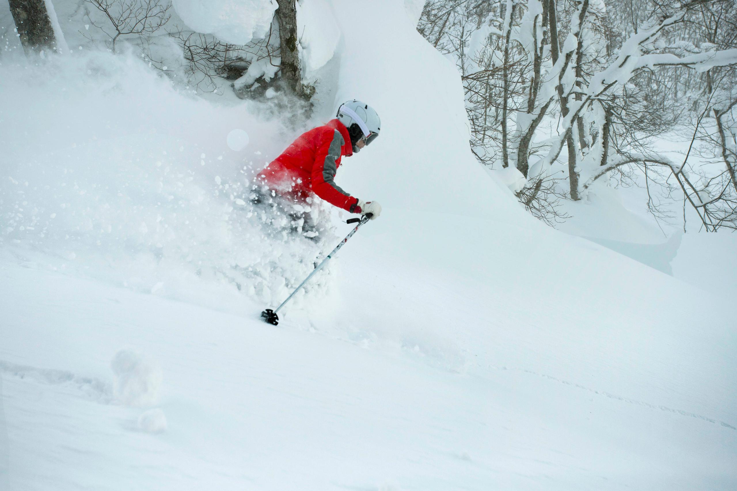 Woman skiing in deep powder in Hokkaido, Japan