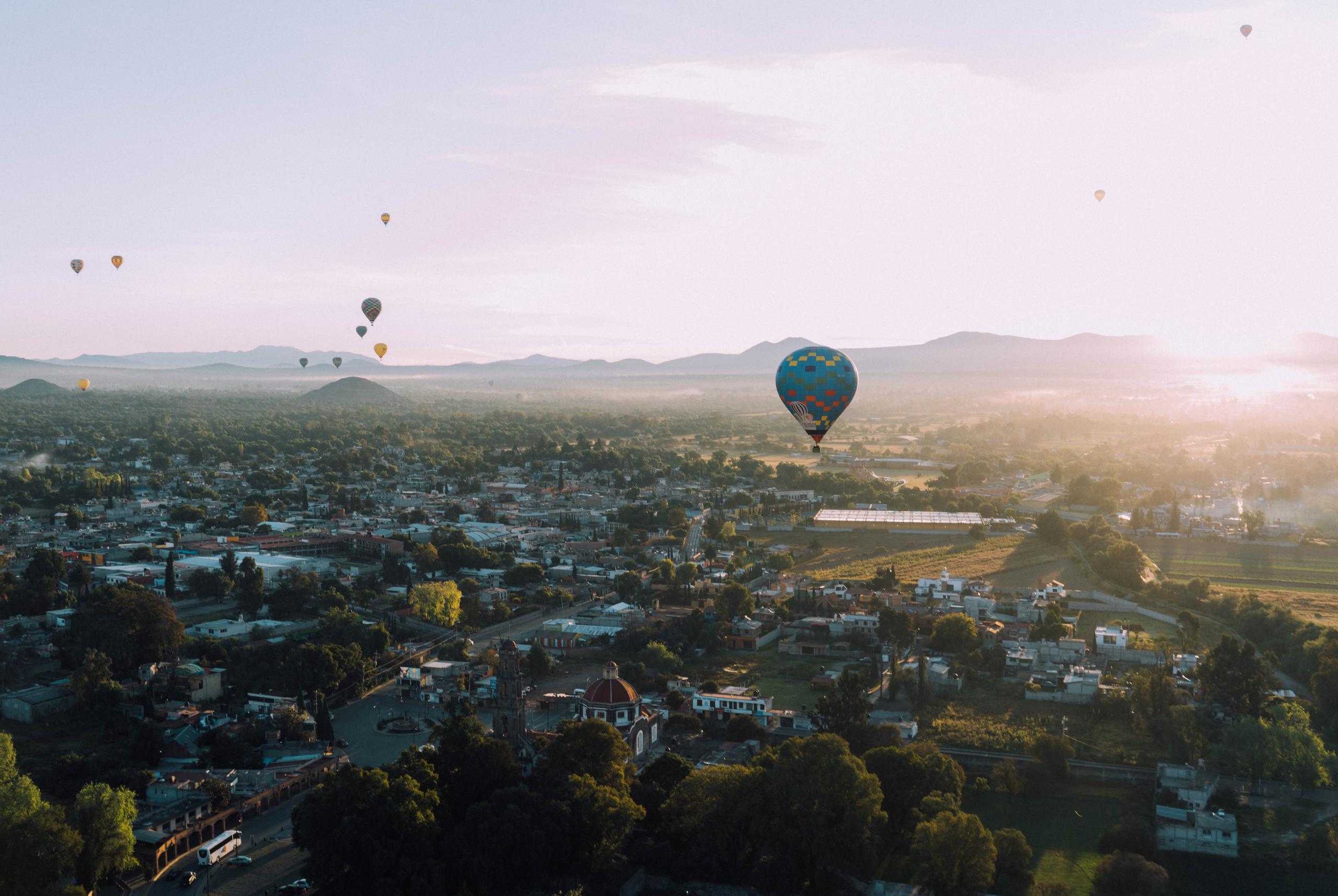 hot air balloons hovering over city