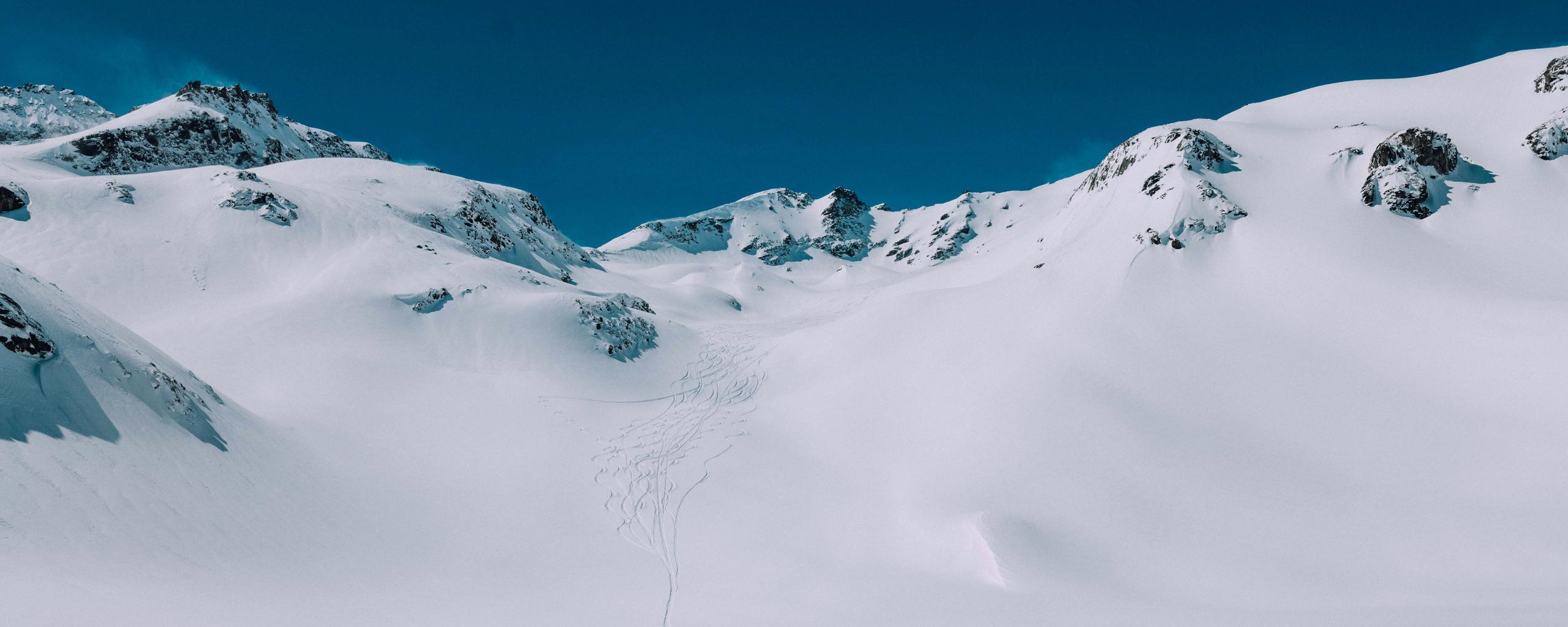Snowy mountain landscape in French Alps with ski tracks