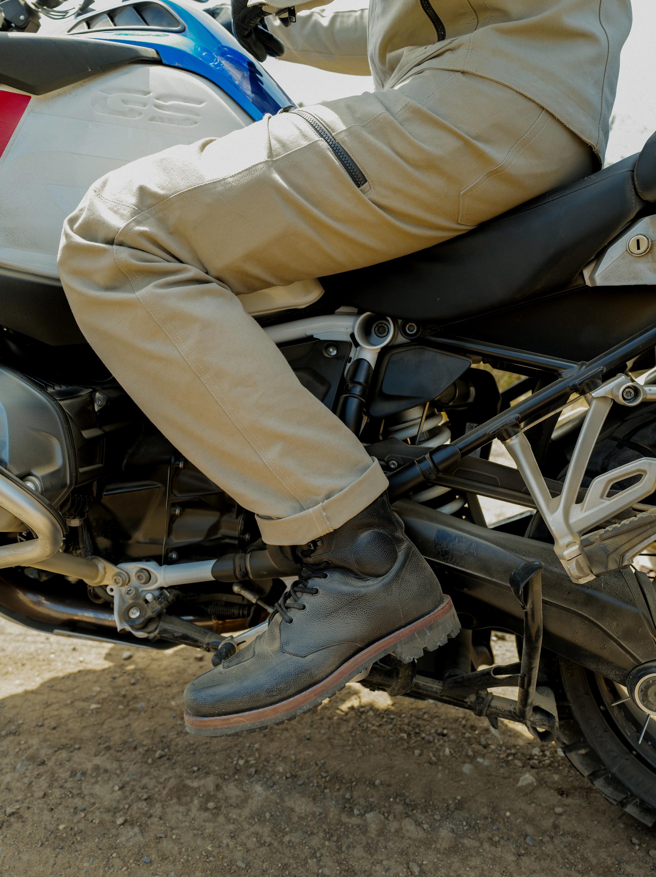 Closeup of motorcyclists' leg and boot on foot rest