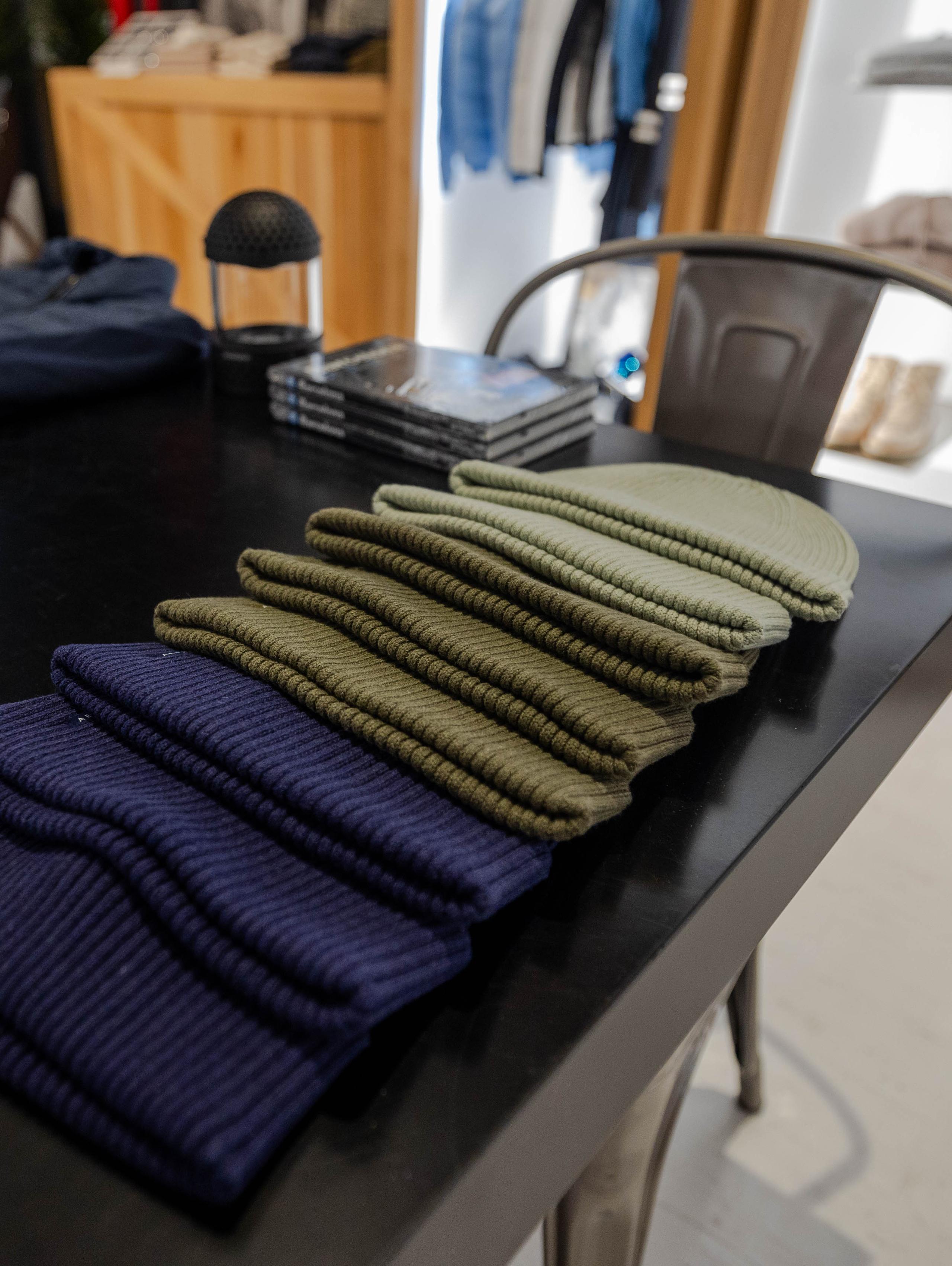 Variety of colored beanies on table display