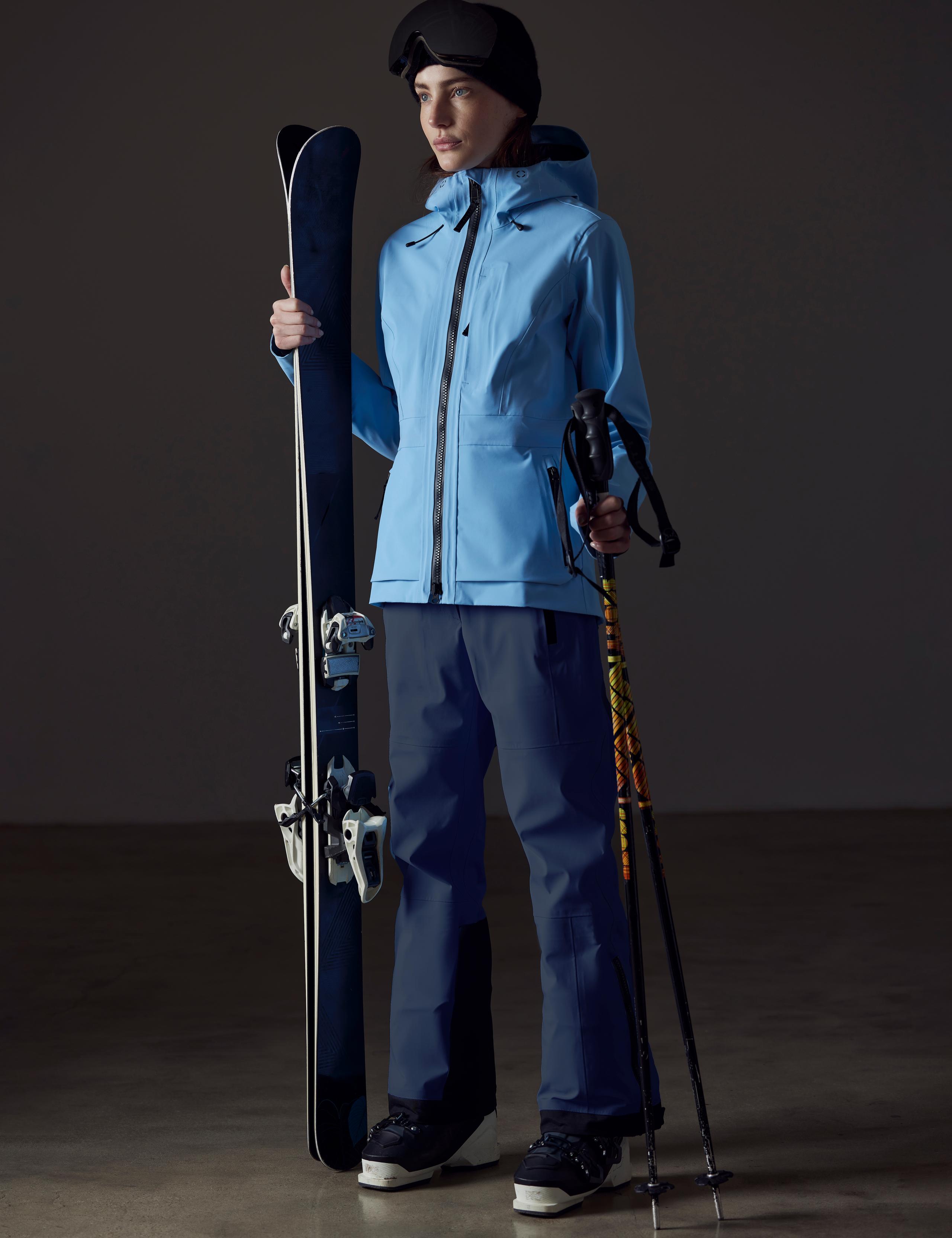 A woman in Boyd Ski Jacket holding skis