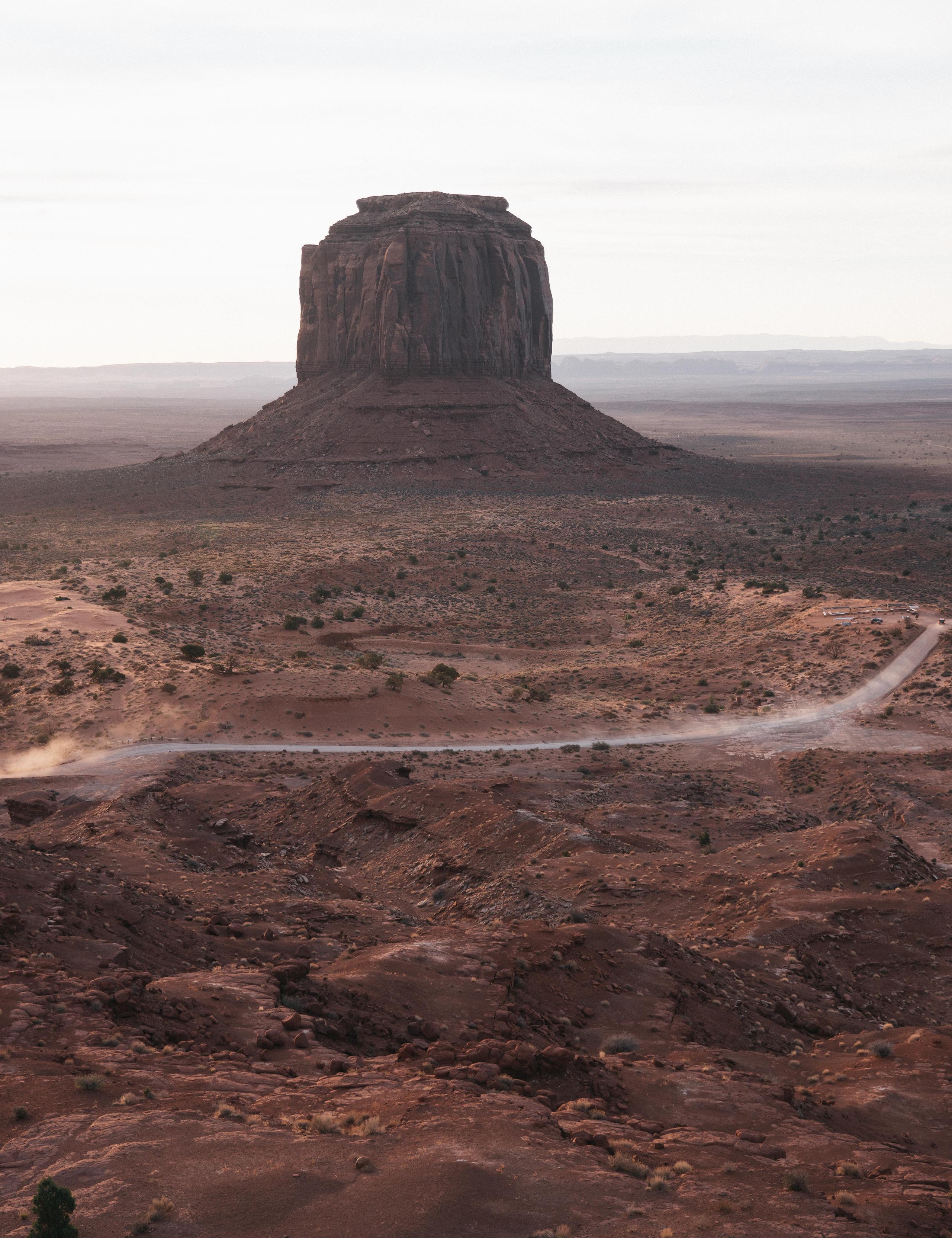 Landscape of Monument Valley and a road winding through it