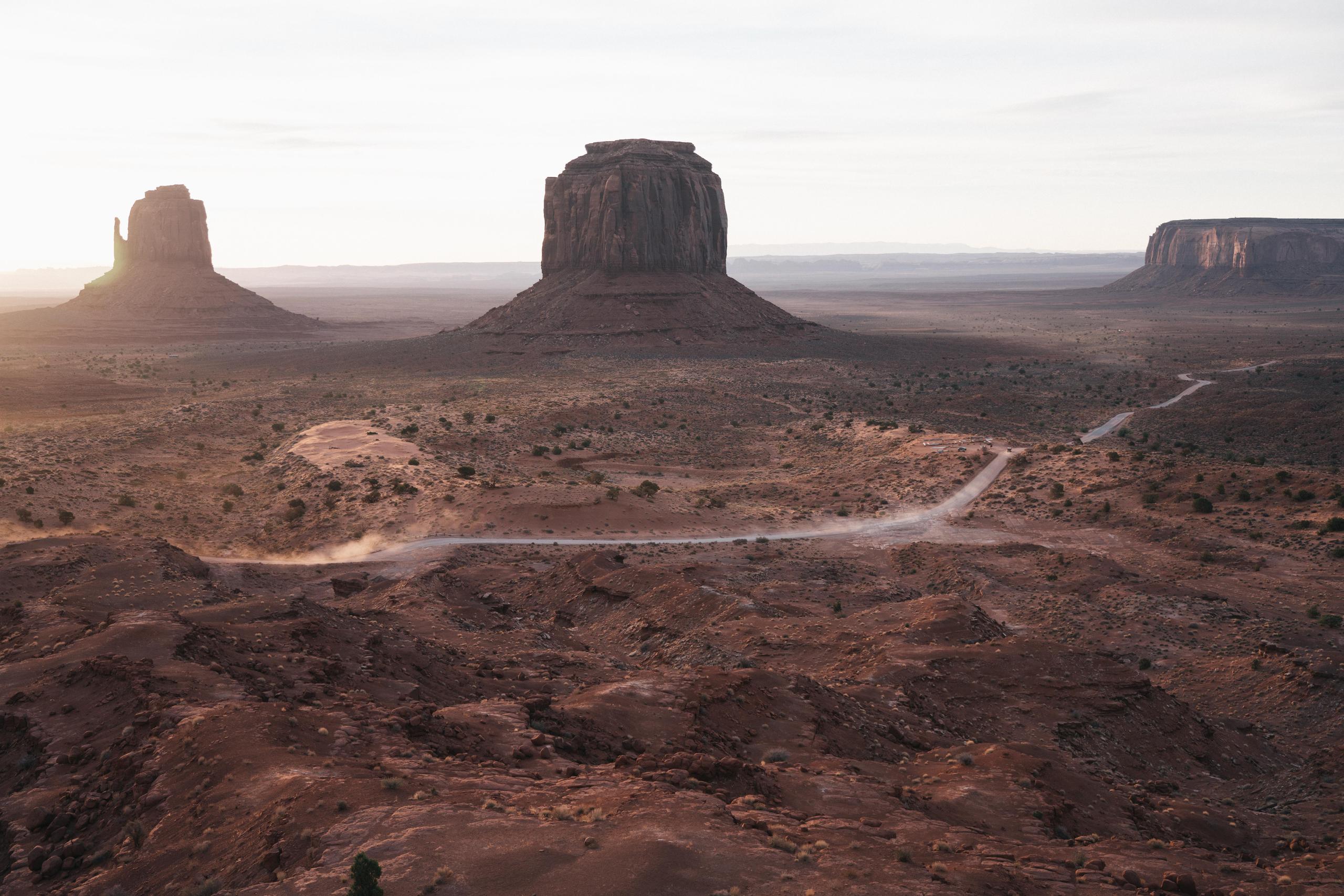 Landscape of Monument Valley and a road winding through it