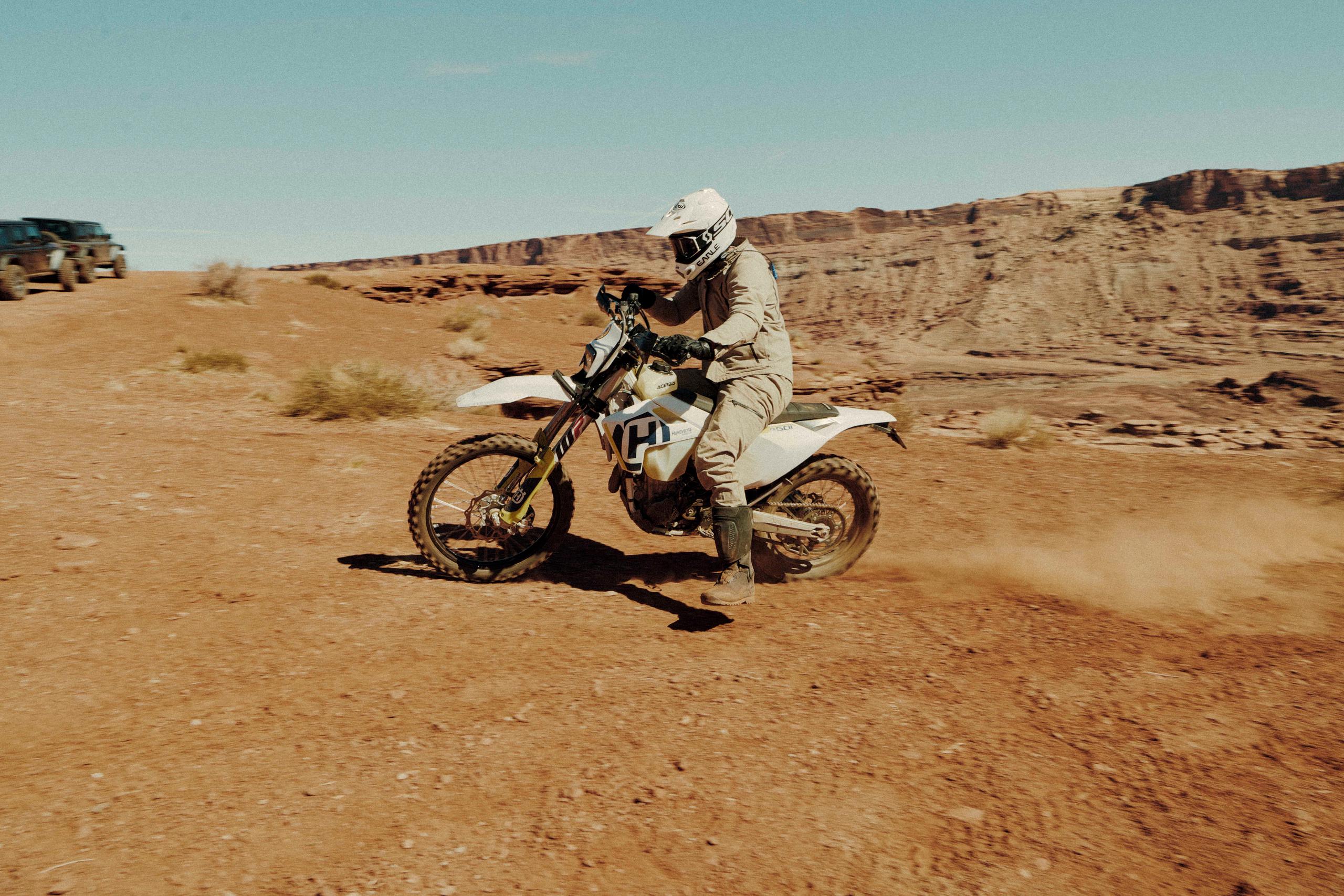 Motorcyclist turning on dirt landscape in Utah