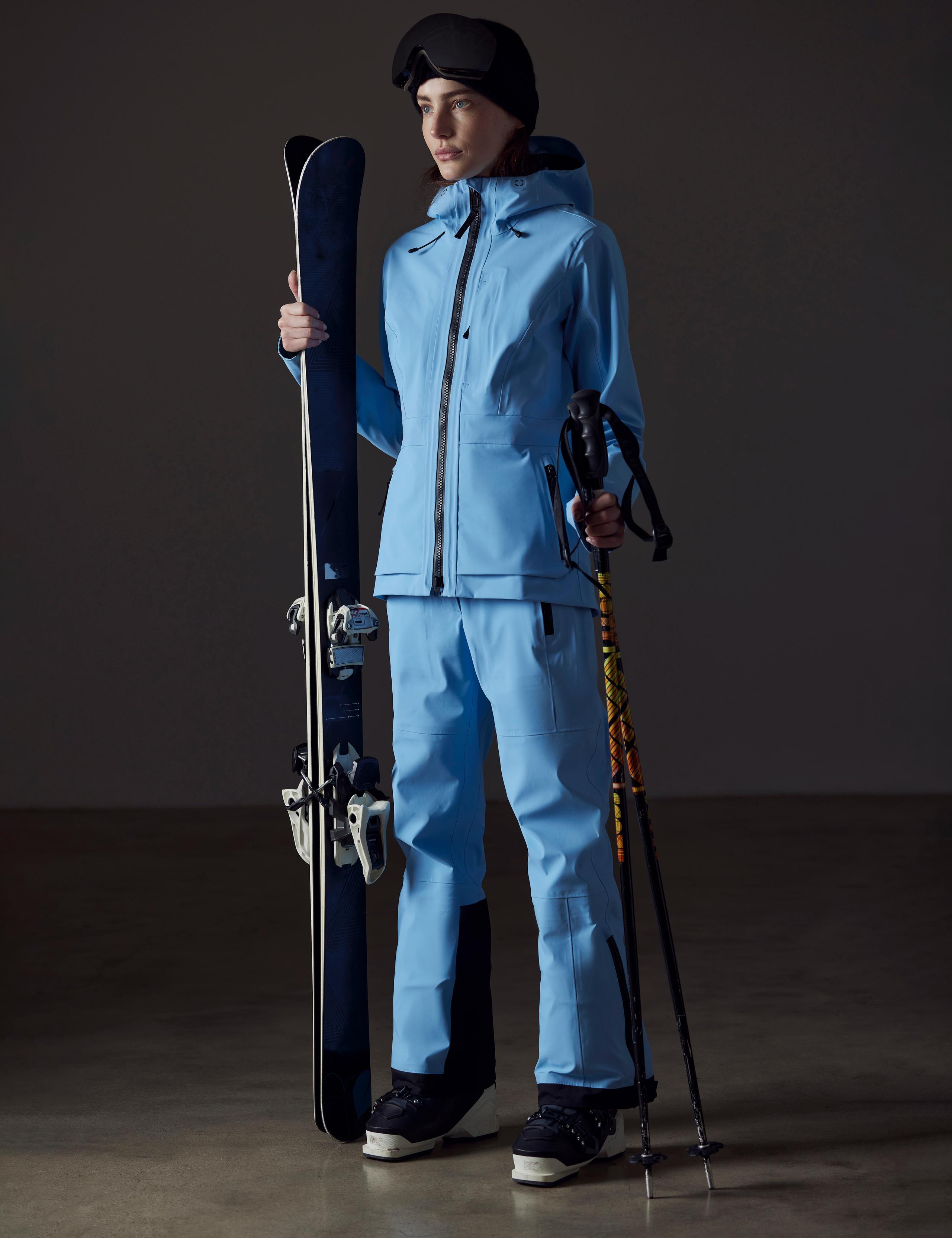 A woman in Boyd Ski Jacket holding skis