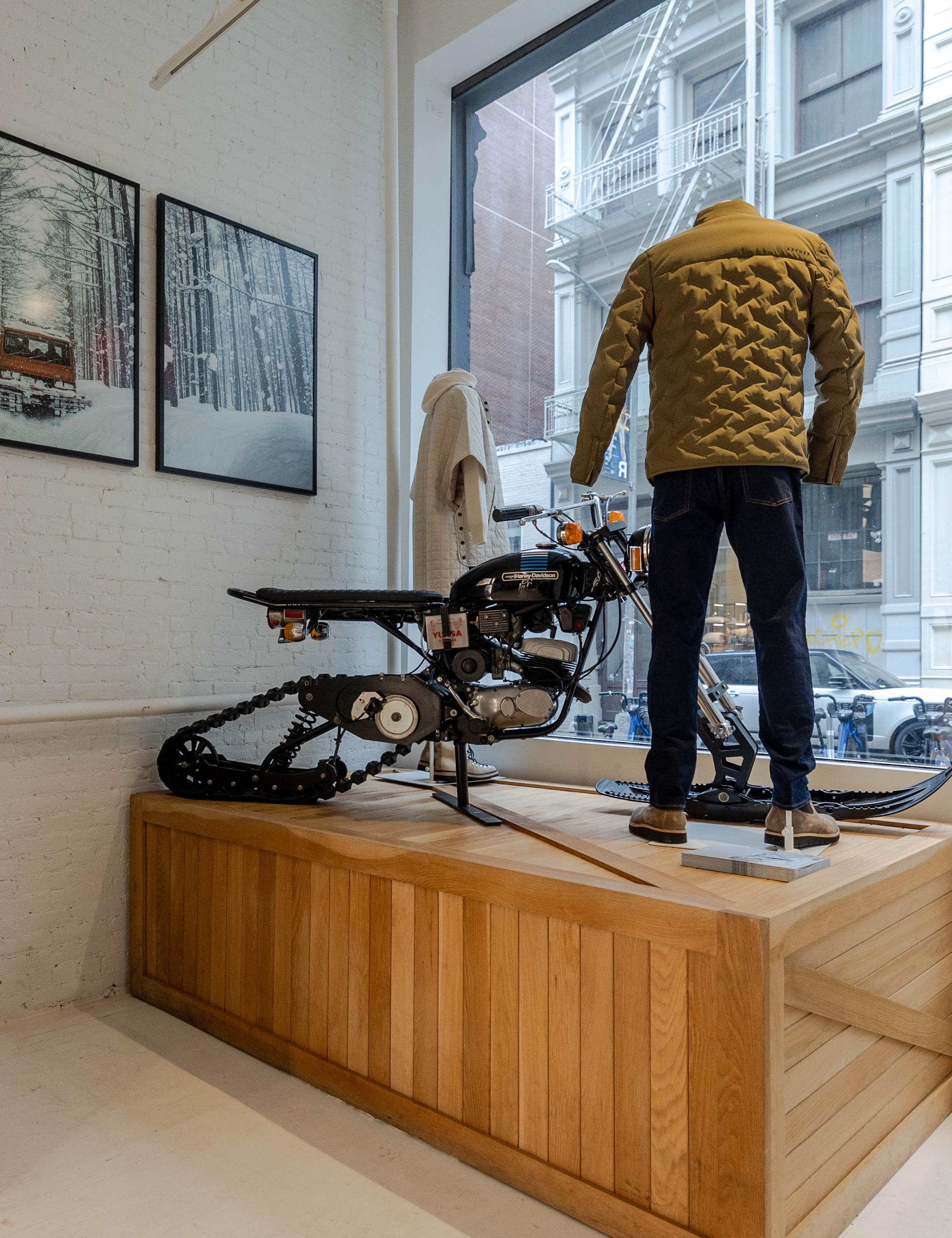 Interior view of front window display with Harley snow bike and mannequins