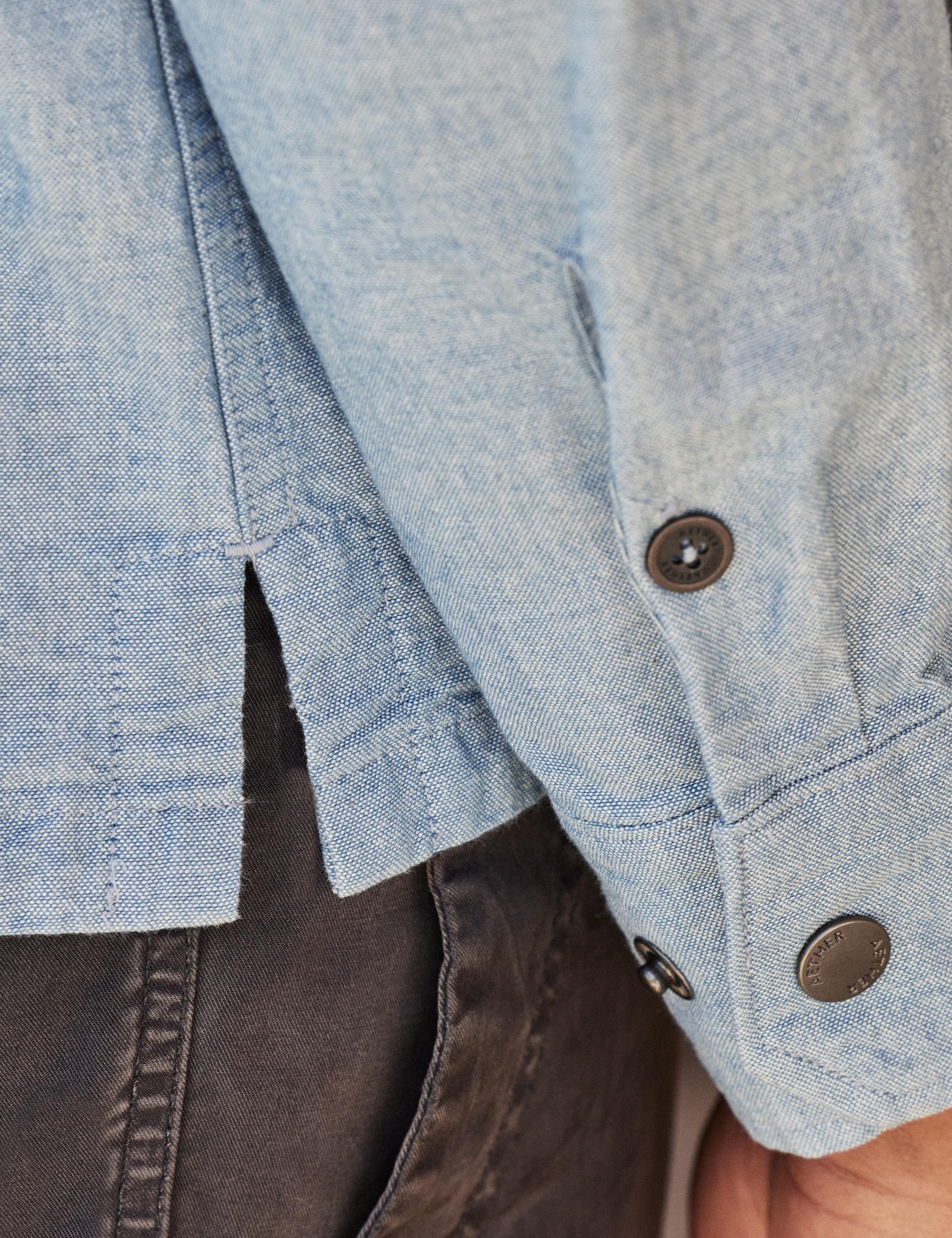 Detail of button sleeve of man wearing Chambray Button-Down