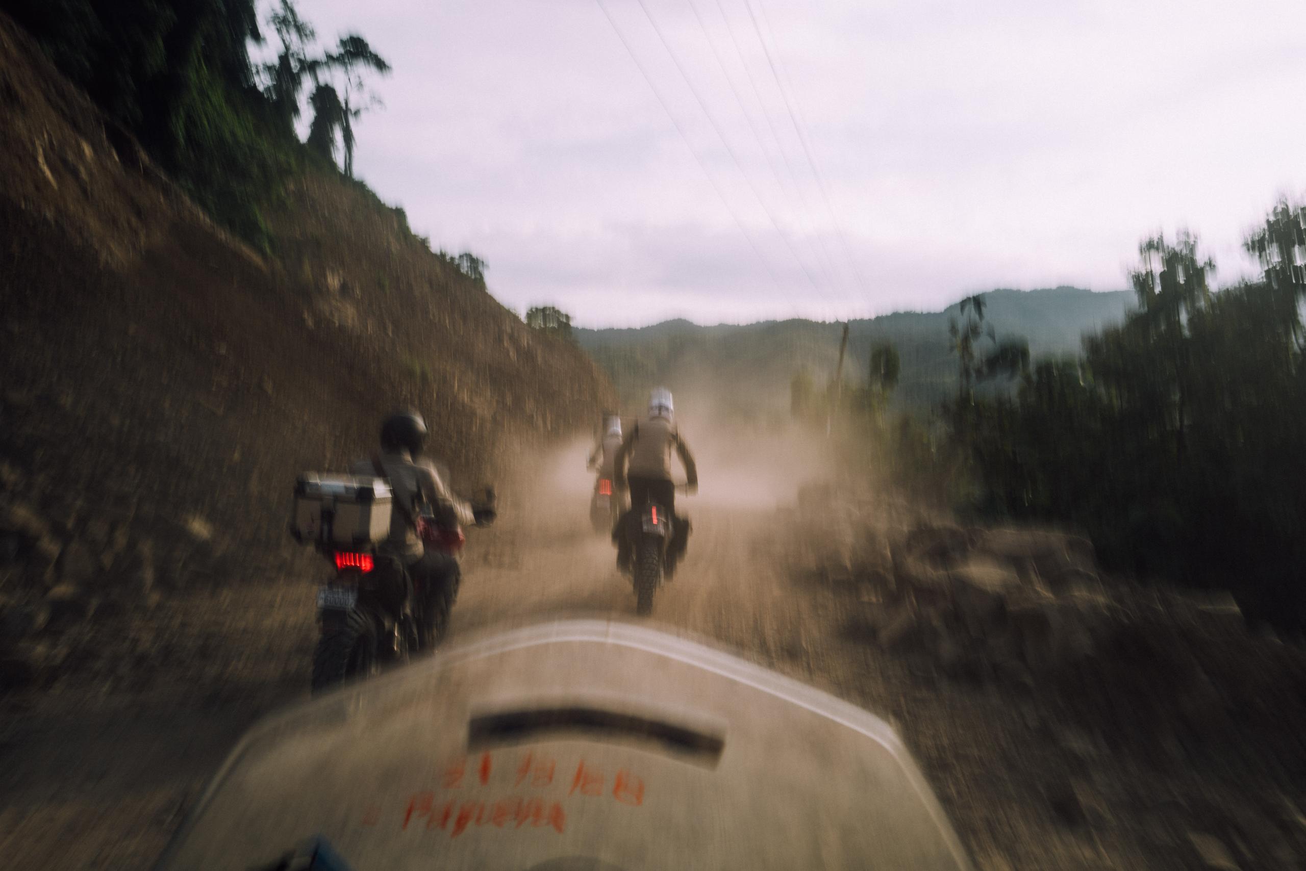 Point-of-view photo of motorcyclist riding down dirt road in Costa Rica