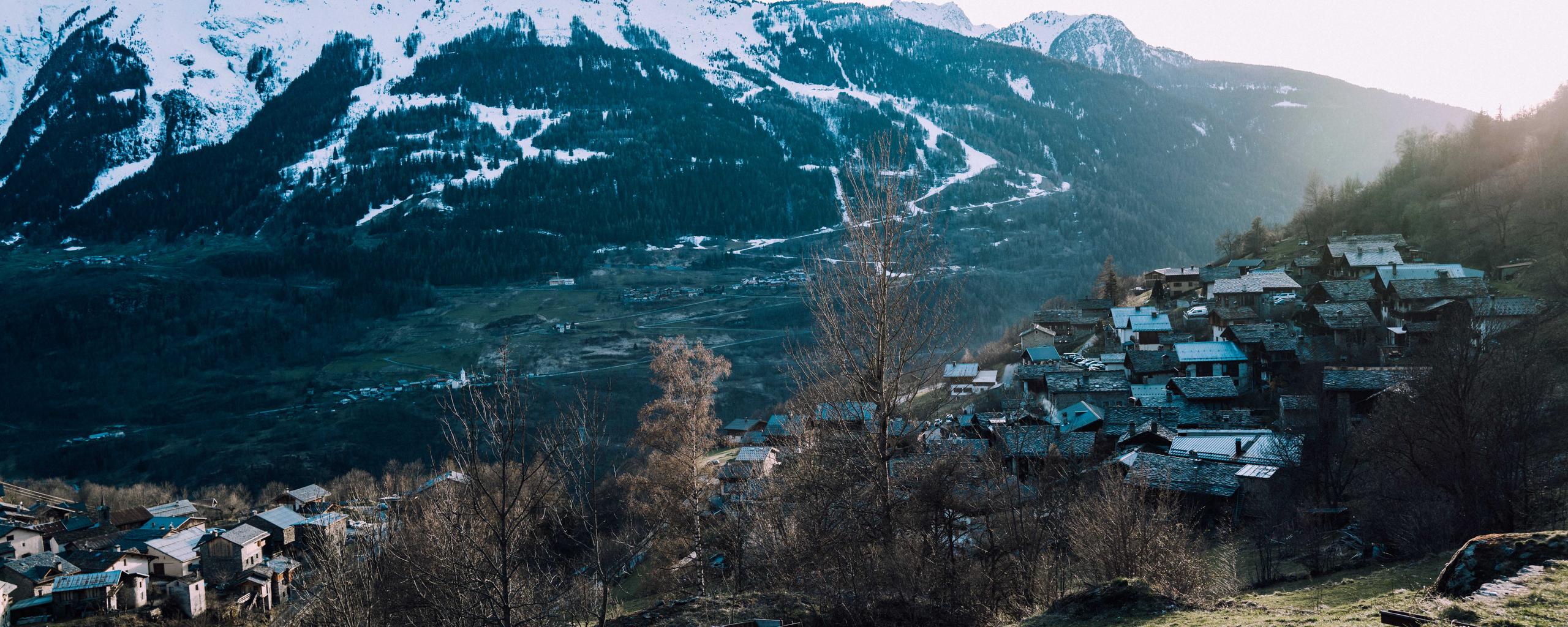 Landscape of homes in front of snowy French Alps