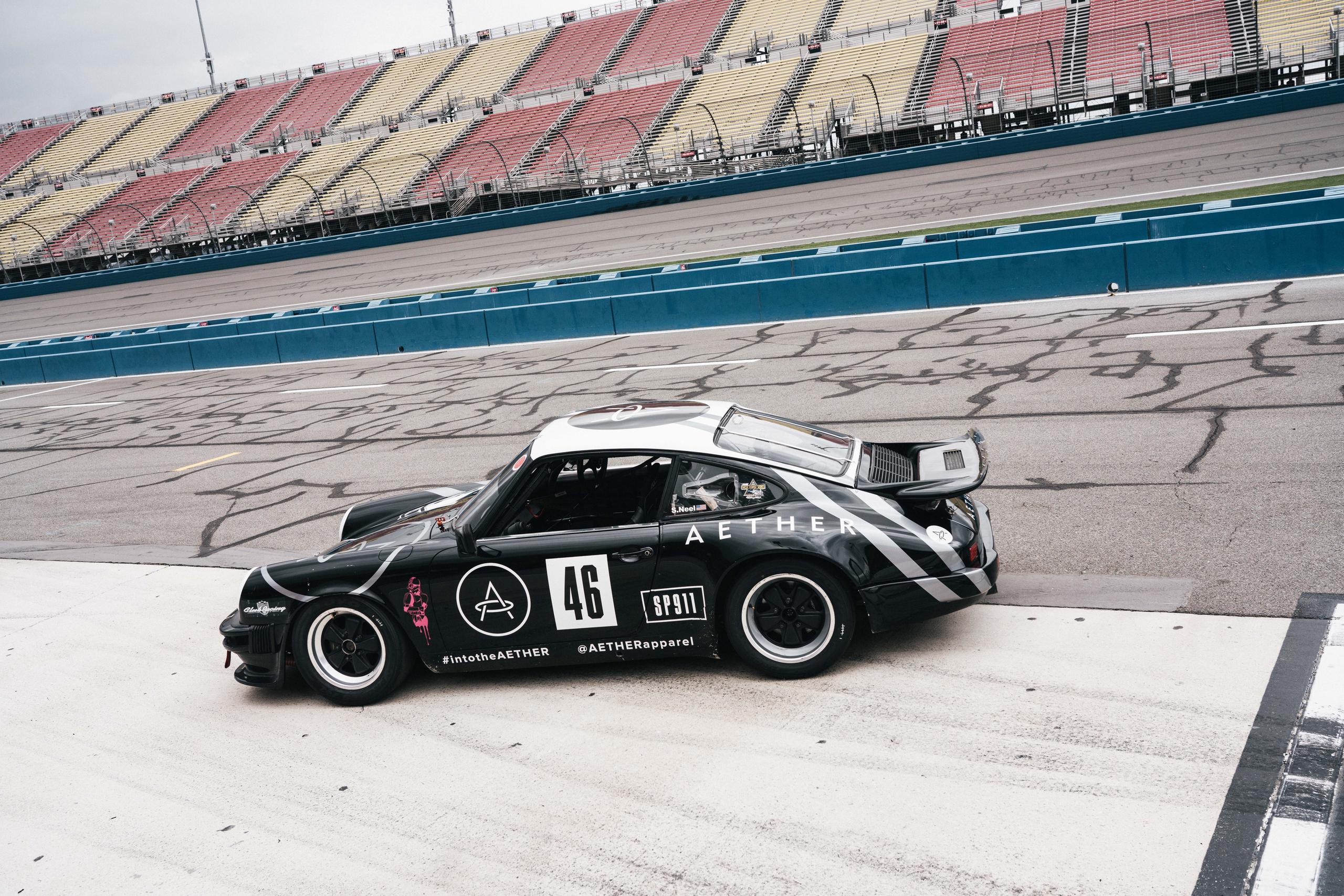 Aether branded Porsche car on race track