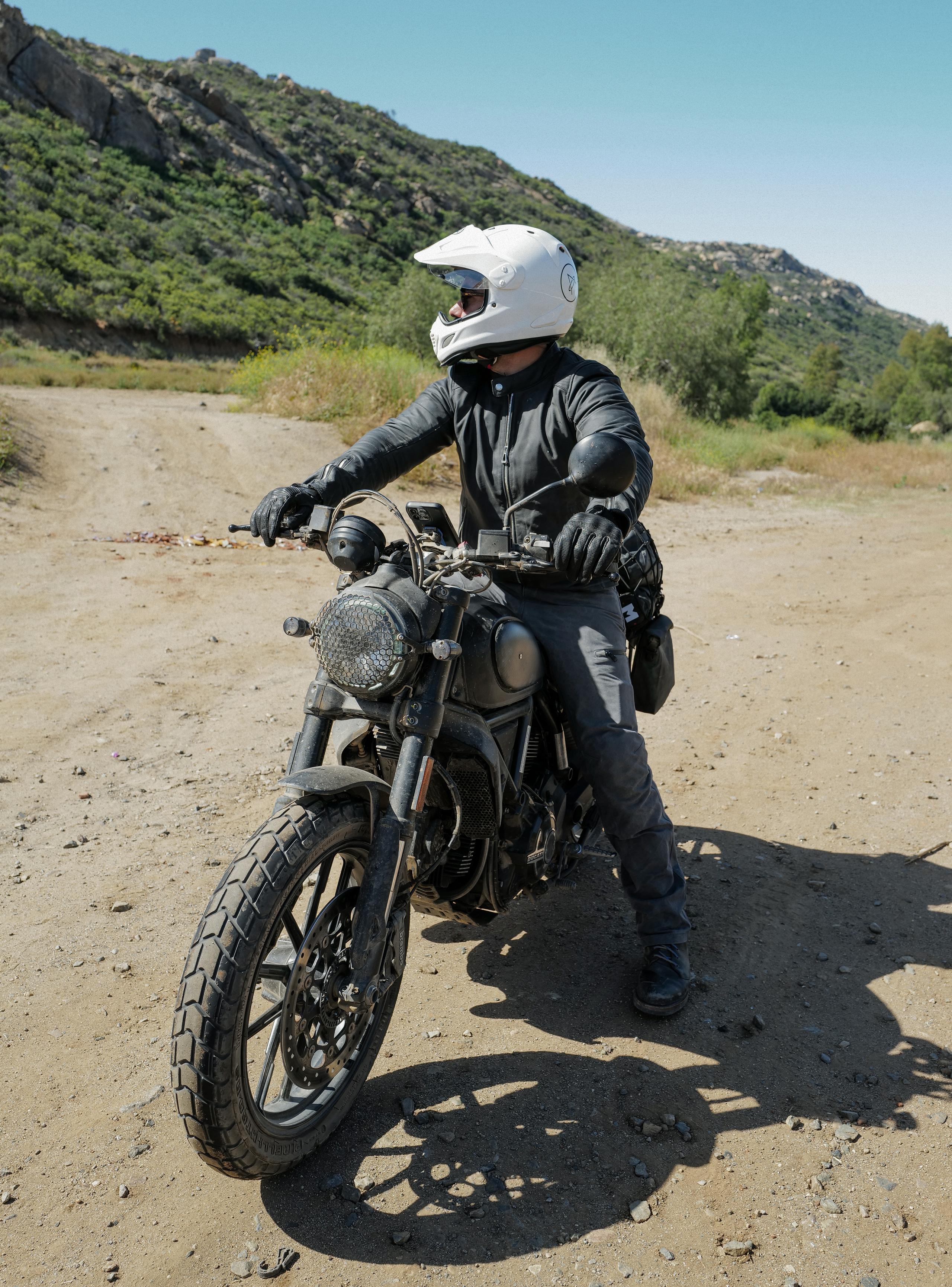 Motorcyclist idling on dirt path in Baja California