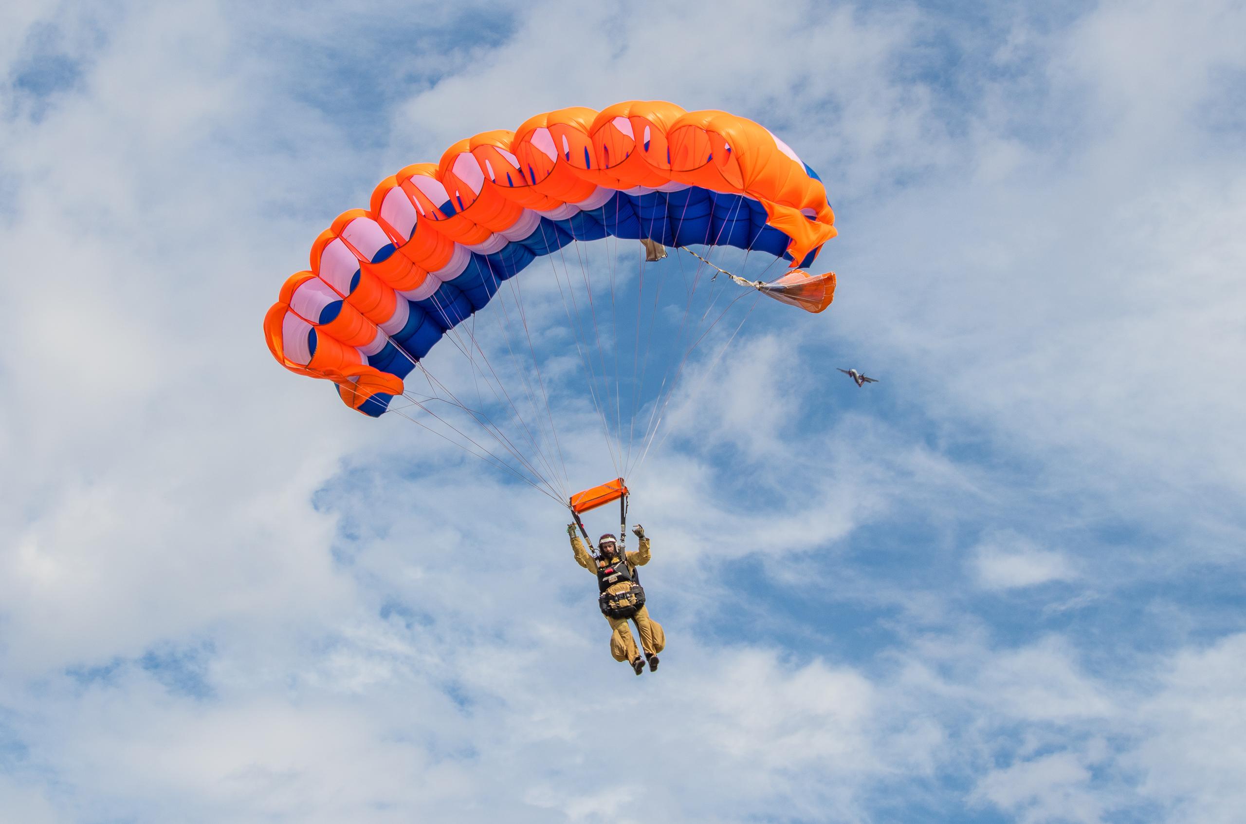 Smokejumper middair with parachute deployed