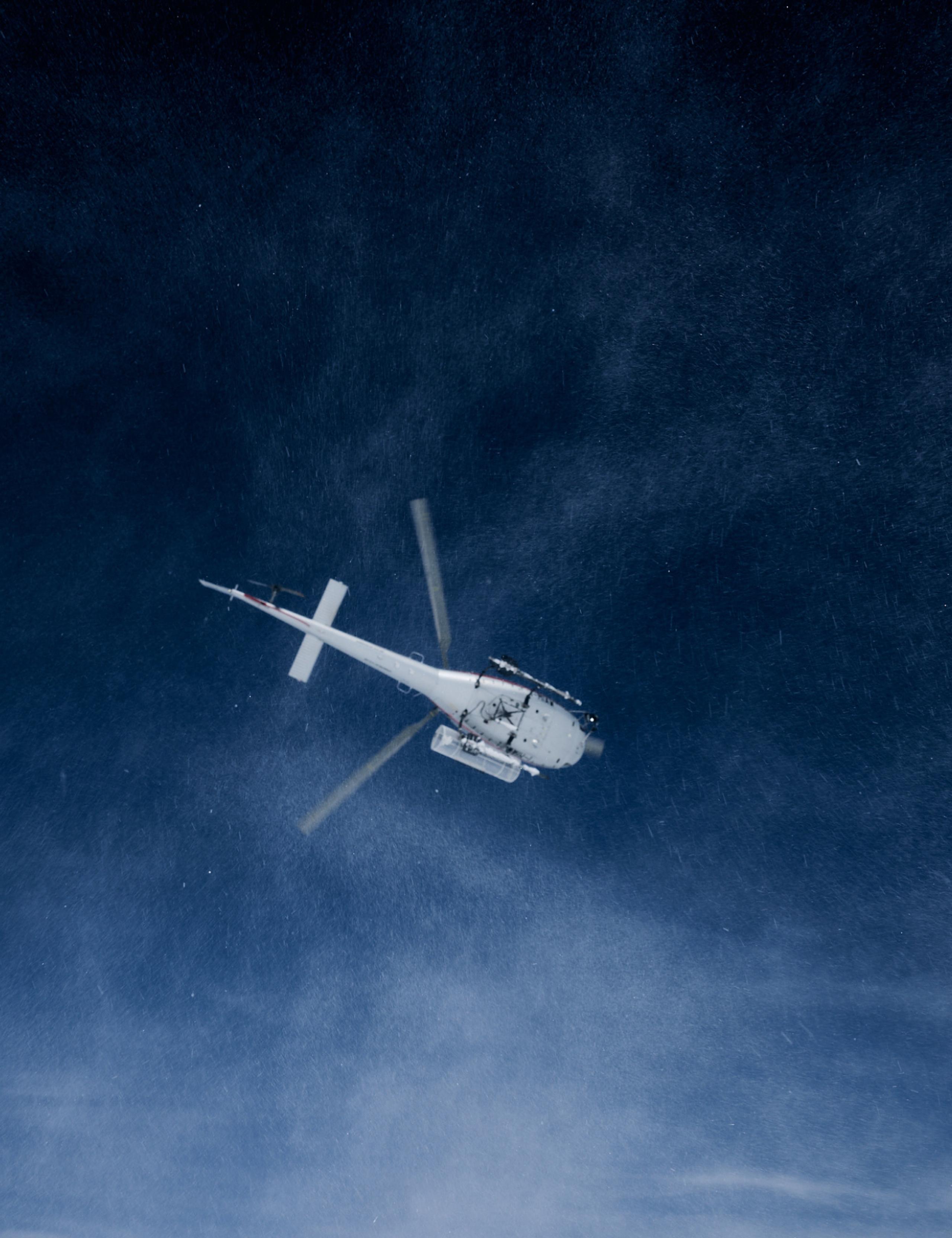 A chopper in the dark blue sky.